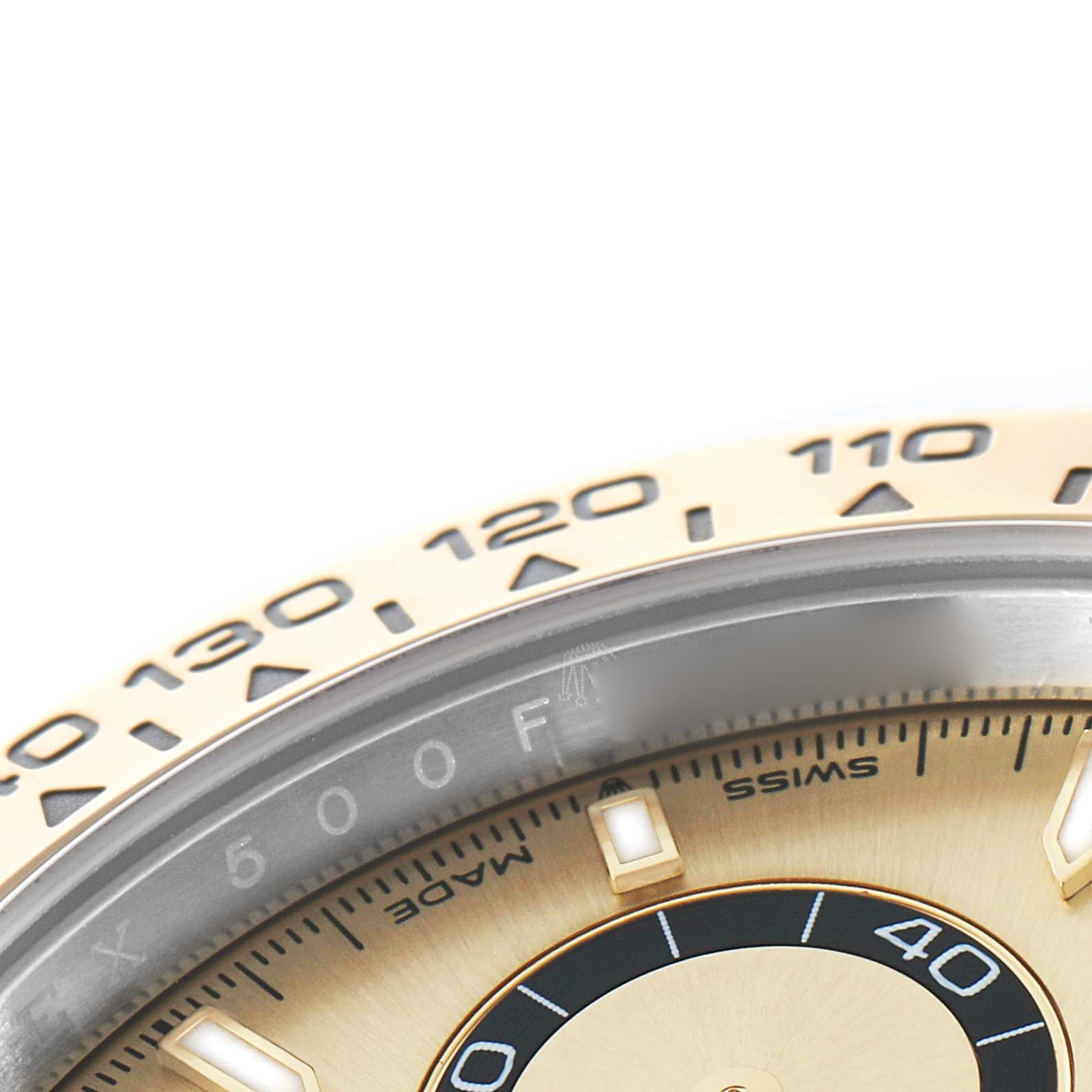 The image shows a close-up of the bezel and part of the dial of a Rolex Daytona 126503 Men's Steel and Gold (two tone) Champagne Dial, highlighting the tachymetric scale.