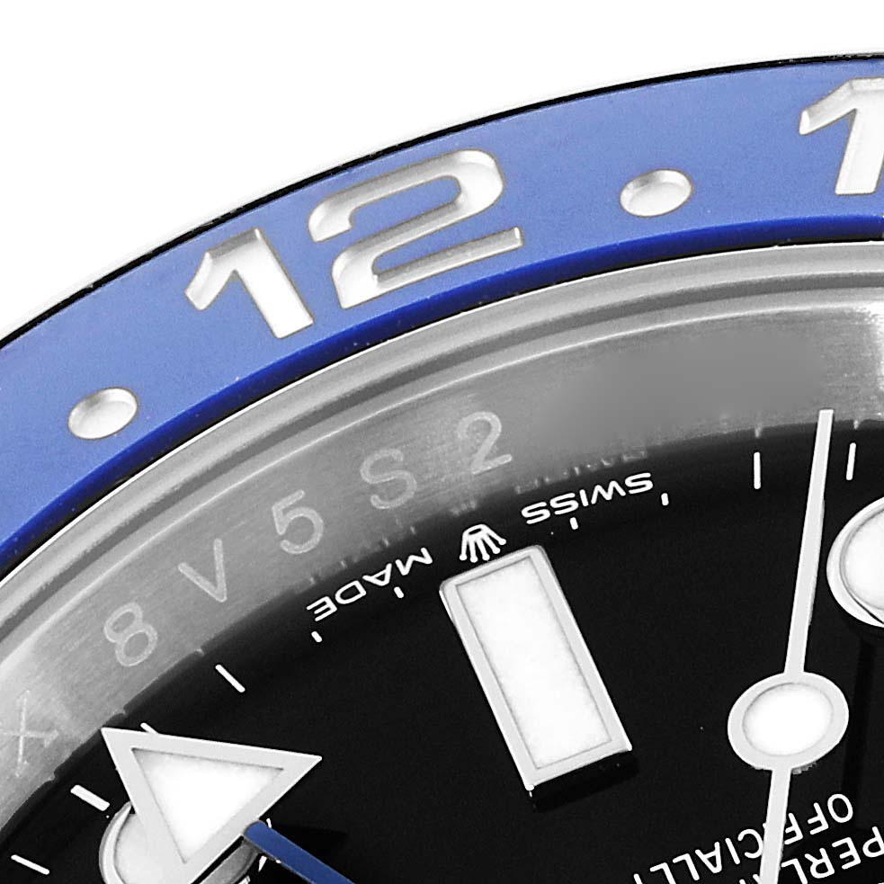 This image shows a close-up of the GMT-Master by Rolex, highlighting the bezel and partial watch face at an angled view.