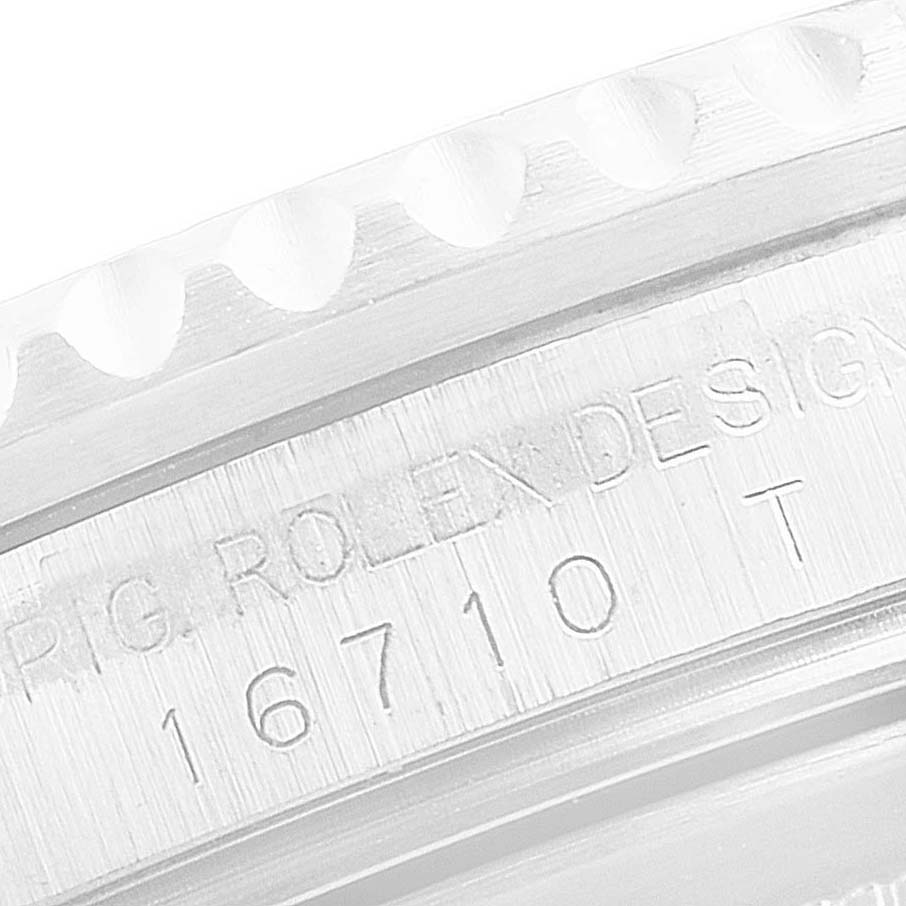 This close-up image shows the engraved serial number and part of the bezel on a Rolex GMT-Master 16710 Men
s Stainless Steel Black Dial 16710 Men
s Stainless Steel Black Dial model.