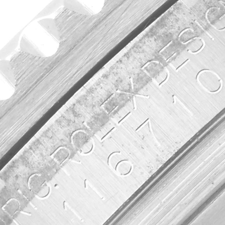 The image shows a close-up of the engraved side of the Rolex GMT-Master 116710 Men
s Stainless Steel Black Dial 116710 Men
s Stainless Steel Black Dial watch case near the bezel.