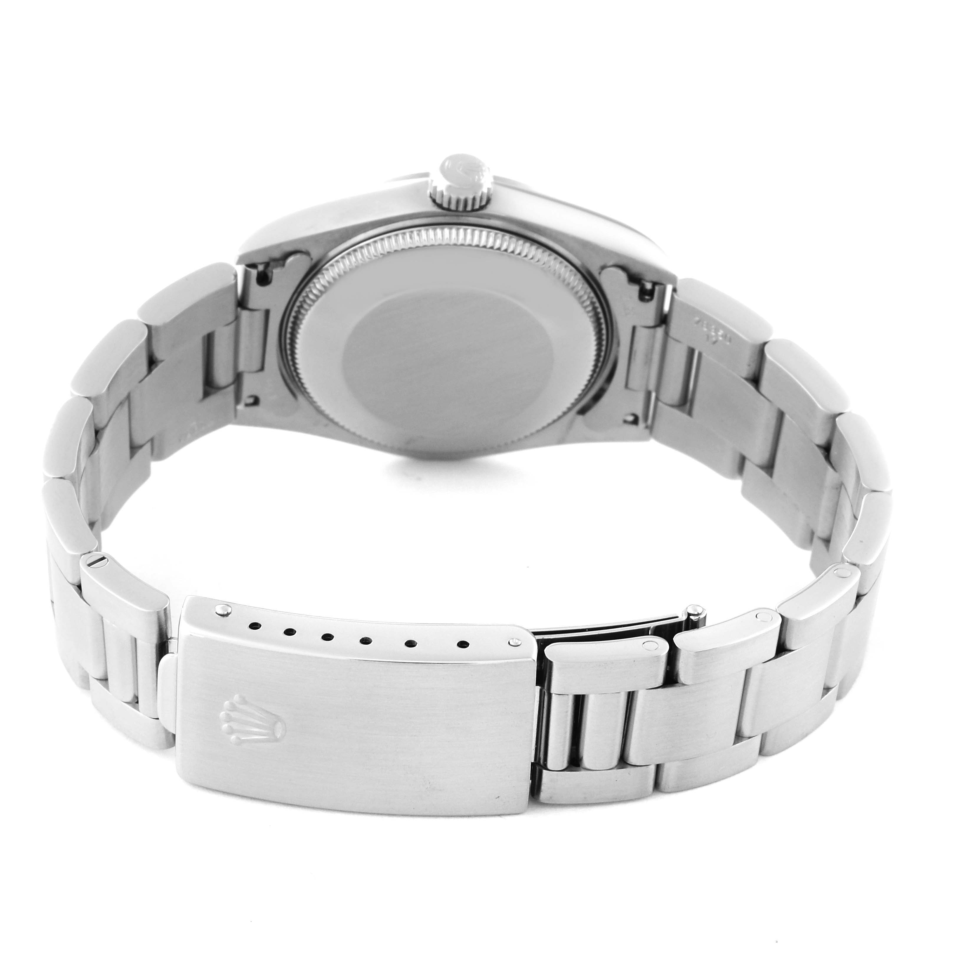 The image shows the back of a Rolex Mid-Size 67480 Women's Stainless Steel Black Dial 67480 Women's Stainless Steel Black Dial watch, featuring the bracelet, clasp, and case back.