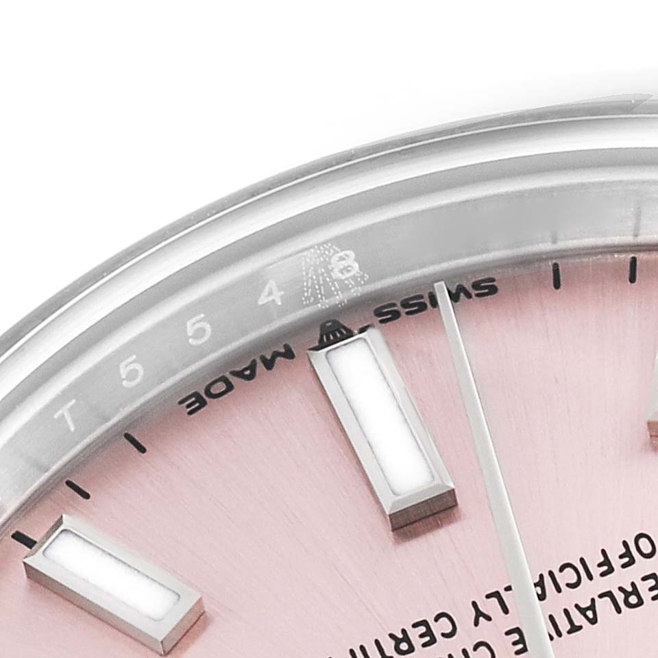 This image shows a close-up of the face and bezel of a mid-size Rolex watch, highlighting the Swiss Made label and hour markers.
