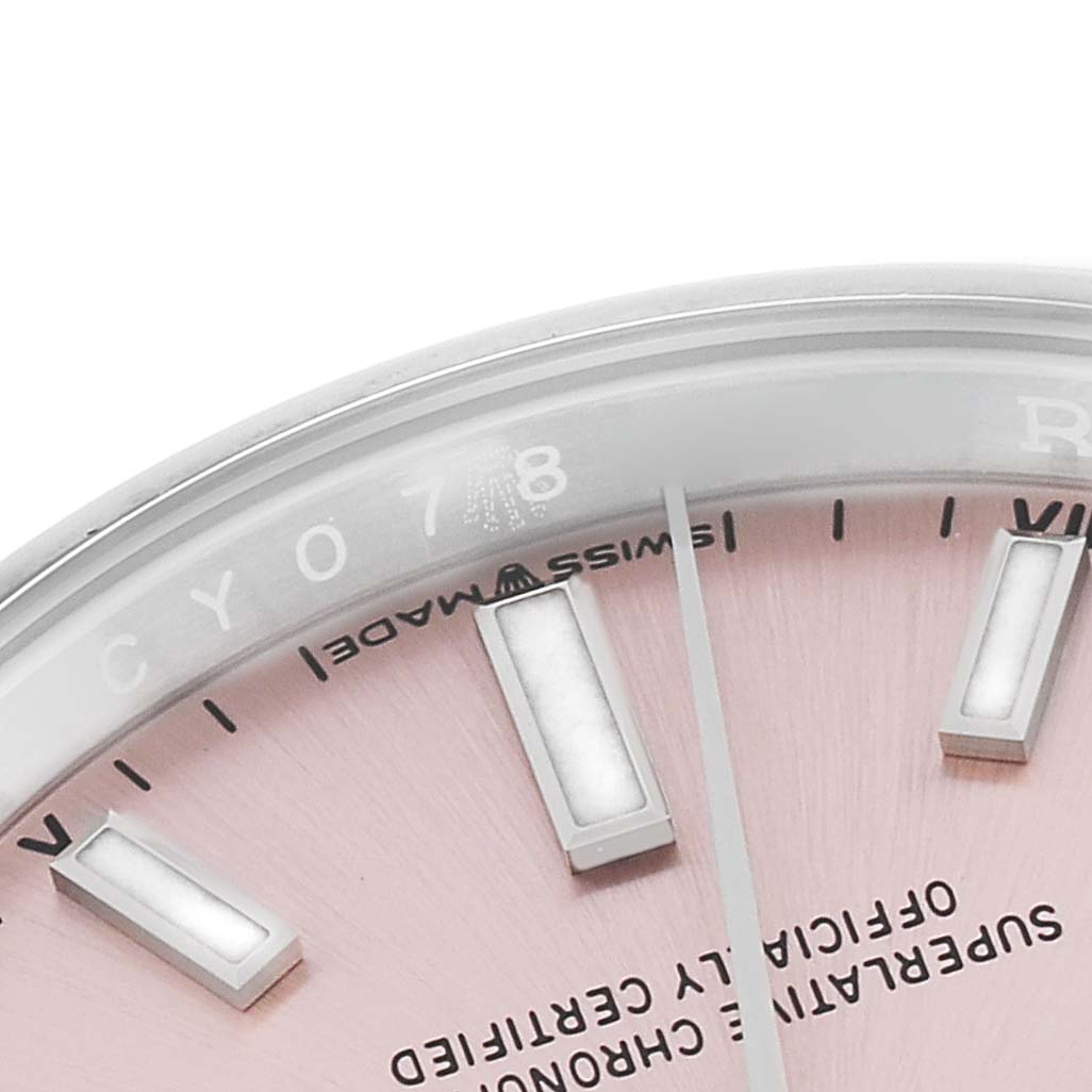 This image shows a close-up of the dial and part of the bezel of a Rolex Oyster Perpetual 124200 Men's Stainless Steel Pink Dial 124200 Men's Stainless Steel Pink Dial watch.