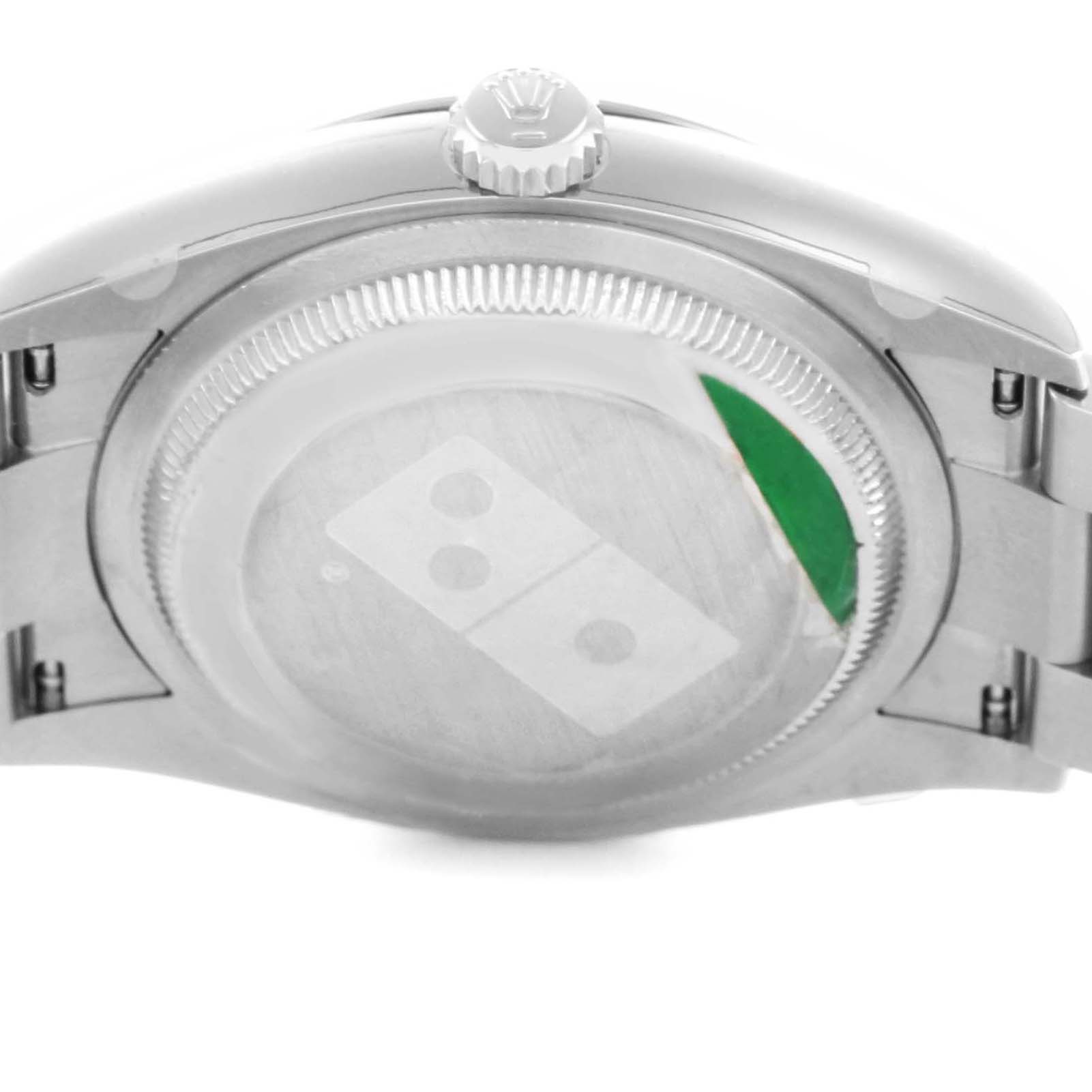 The image shows the back case of a Rolex Oyster Perpetual 126000 Men's Stainless Steel Silver Dial watch, featuring the crown and bracelet from a rear angle.