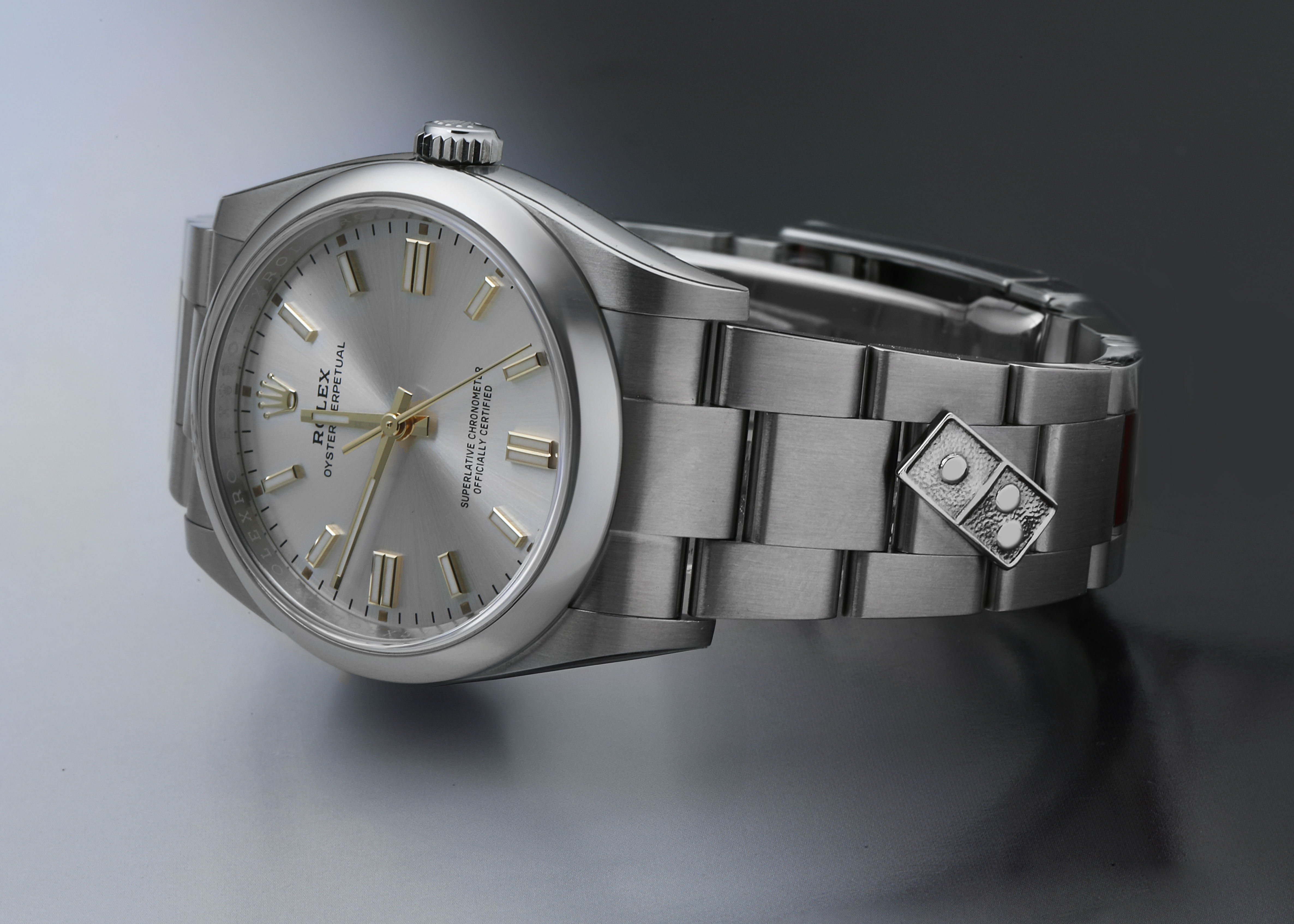 The Rolex Oyster Perpetual 126000 Men's Stainless Steel Silver Dial watch is shown at an angled side view, displaying the face, bezel, crown, and bracelet in detail.