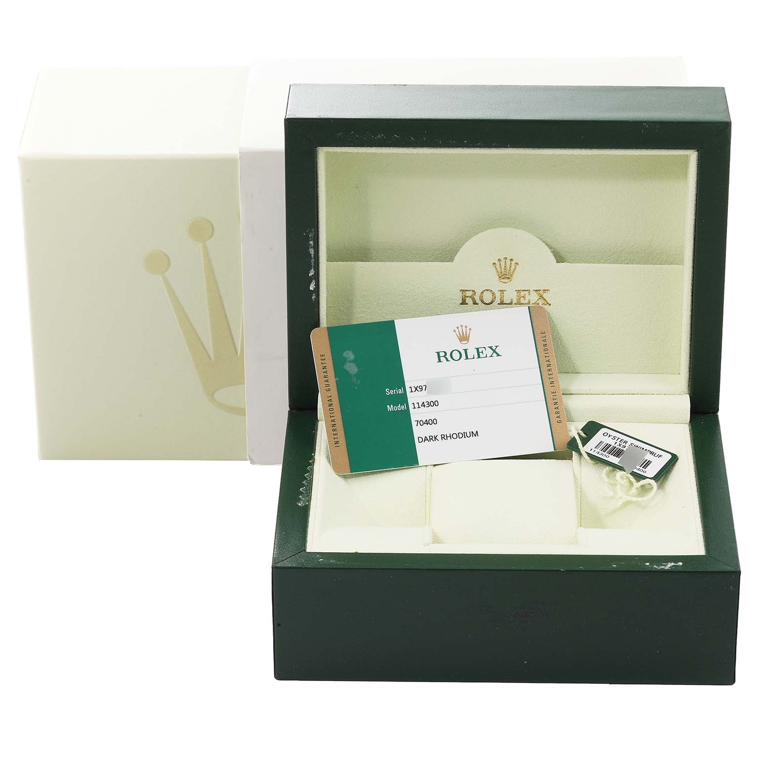 This image shows the packaging, warranty card, and tags for a Rolex Oyster Perpetual 114300 Men's Stainless Steel Grey Dial 114300 Men's Stainless Steel Grey Dial watch.