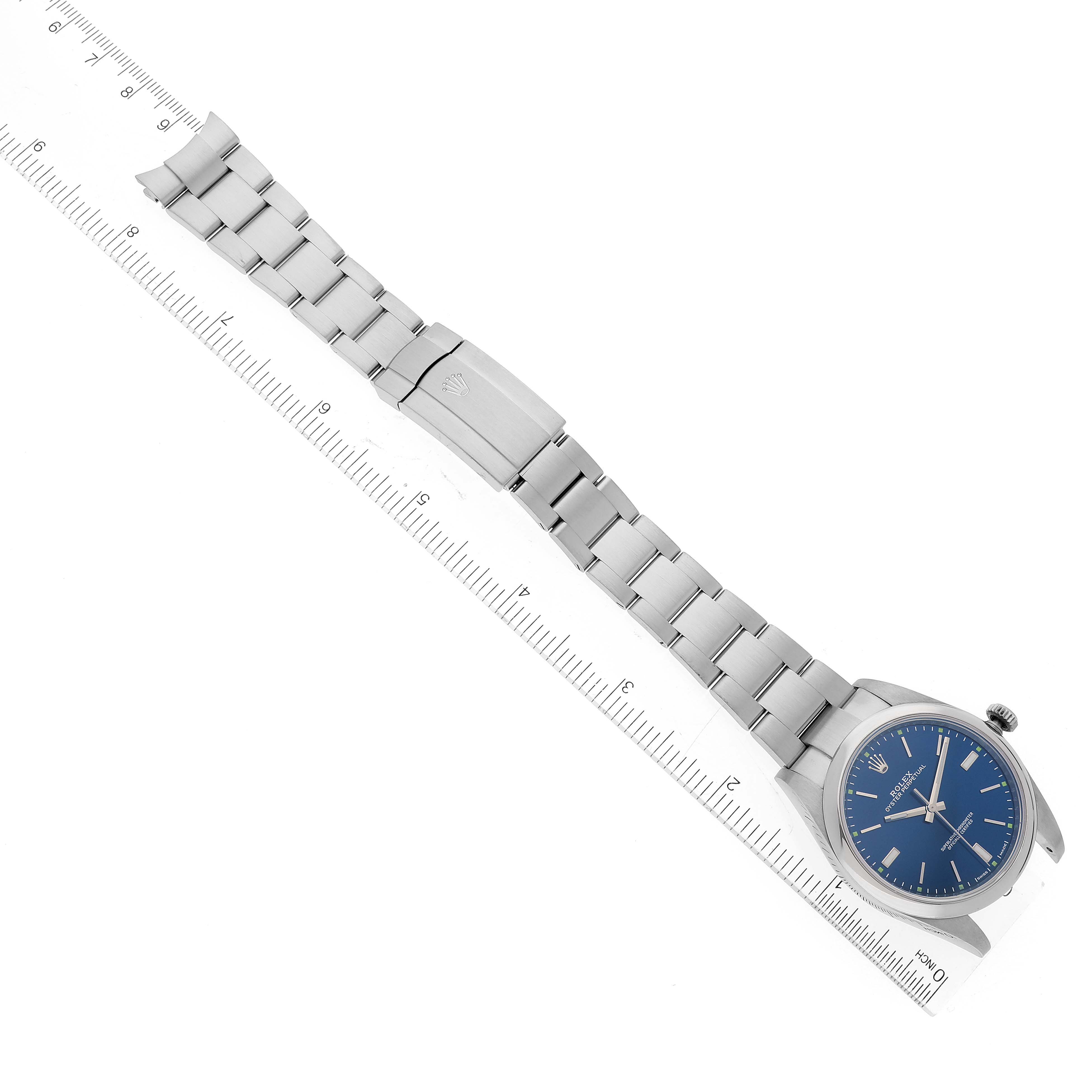 This image shows an overhead view of a Rolex Oyster Perpetual 114300 Men's Stainless Steel Blue Dial 114300 Men's Stainless Steel Blue Dial watch, highlighting the face, bezel, bracelet, and clasp.