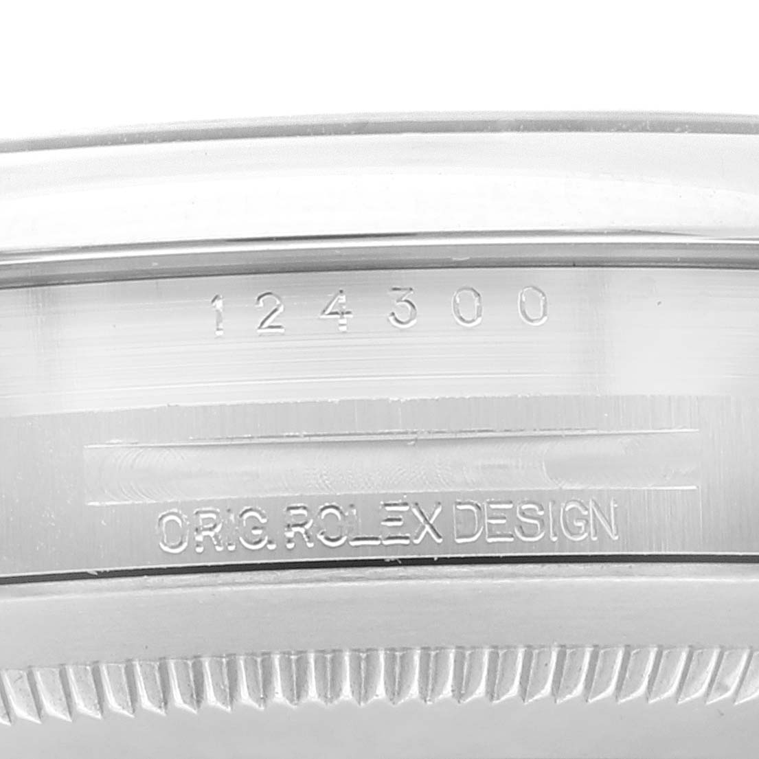 This image shows a close-up of the side of a Rolex Oyster Perpetual 124300 Men
s Stainless Steel Green Dial 124300 Men
s Stainless Steel Green Dial watch case, highlighting the model number "124300" and "ORIG. ROLEX DESIGN" engraving.