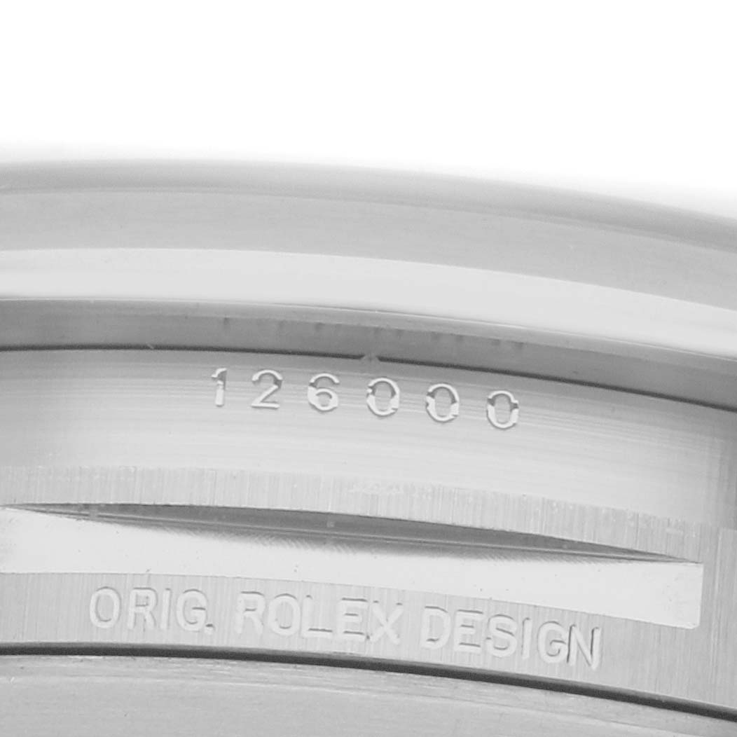 The image shows a close-up of the case side of a Rolex Oyster Perpetual 126000 Men's Stainless Steel Silver Dial, highlighting the engraving with model number.