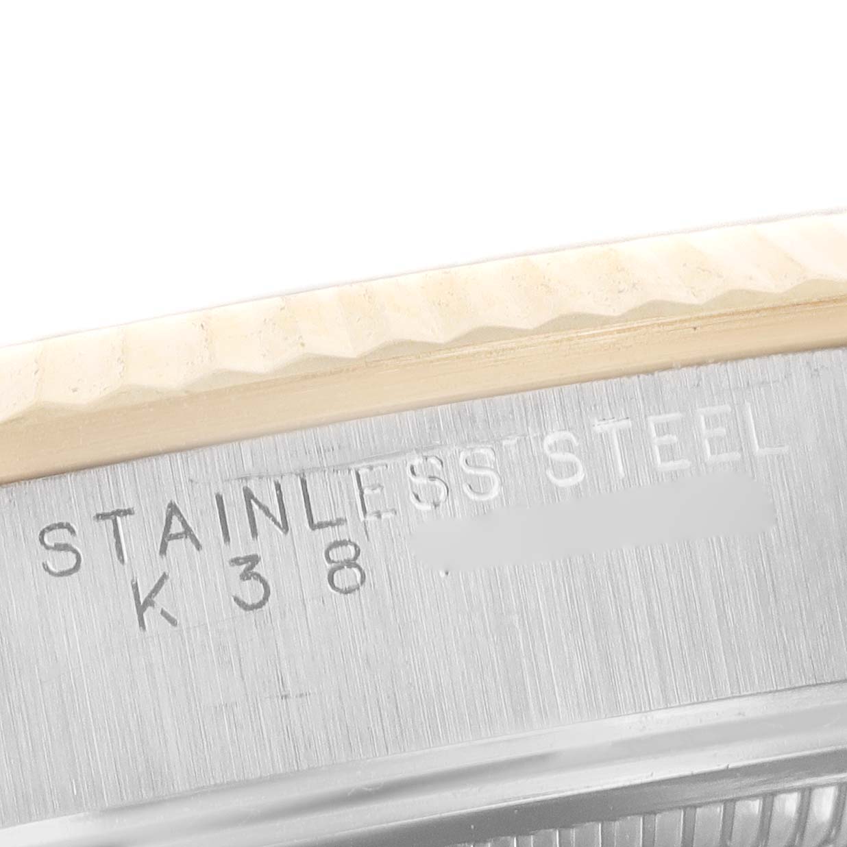 The image shows a close-up view of the edge and engraving on the stainless steel case back of a Rolex Oyster Perpetual 14233 Men's Steel and Gold (two tone) Grey Dial 14233 Men's Steel and Gold (two tone) Grey Dial watch.