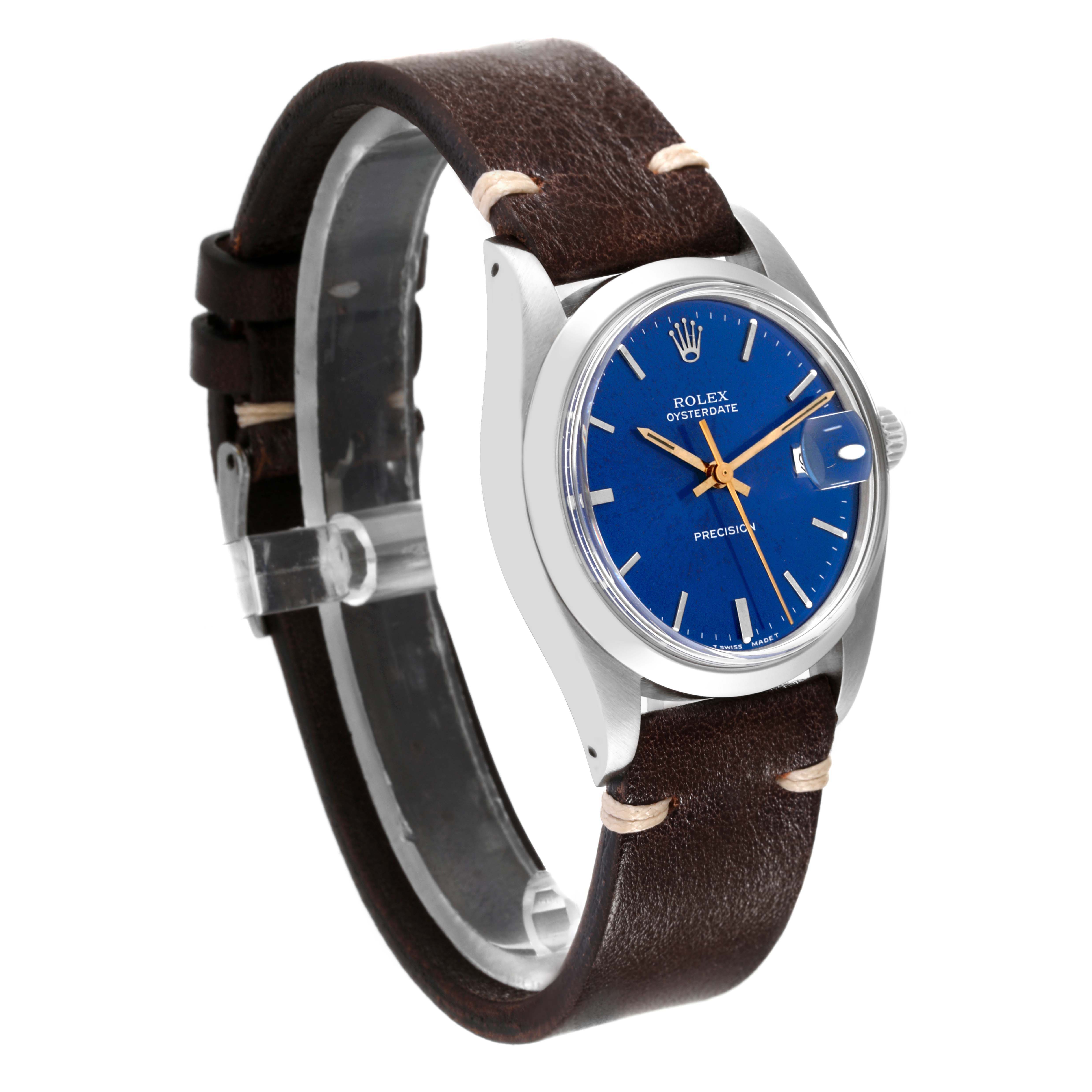 The Vintage Collection model by Rolex is shown from an angled side view, highlighting its blue dial, brown leather strap, and stainless steel case.