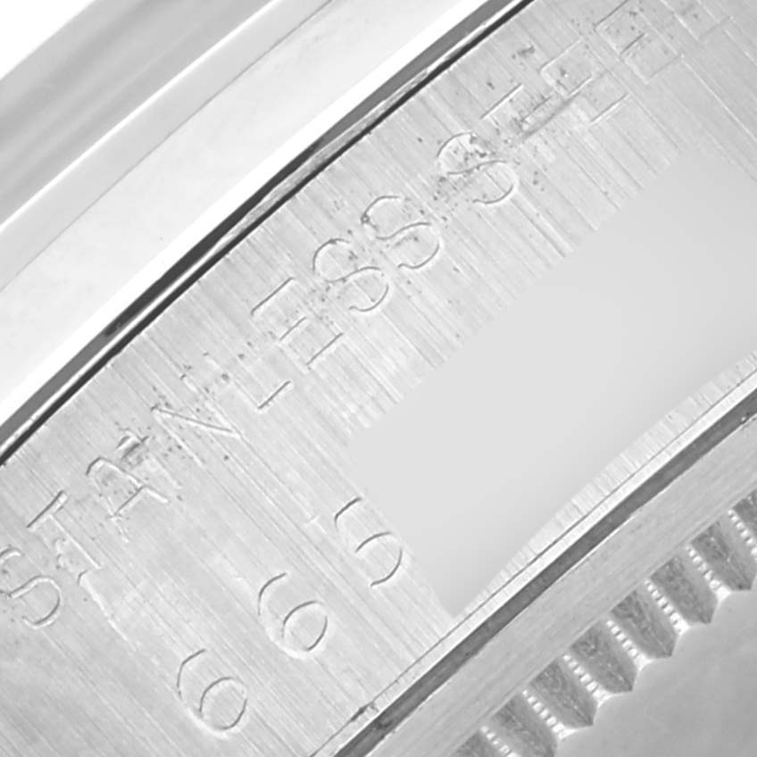 The close-up image shows the engraved part of the stainless steel casing of a Rolex Vintage Collection 6694 Men's Stainless Steel Blue Dial 6694 Men's Stainless Steel Blue Dial model.