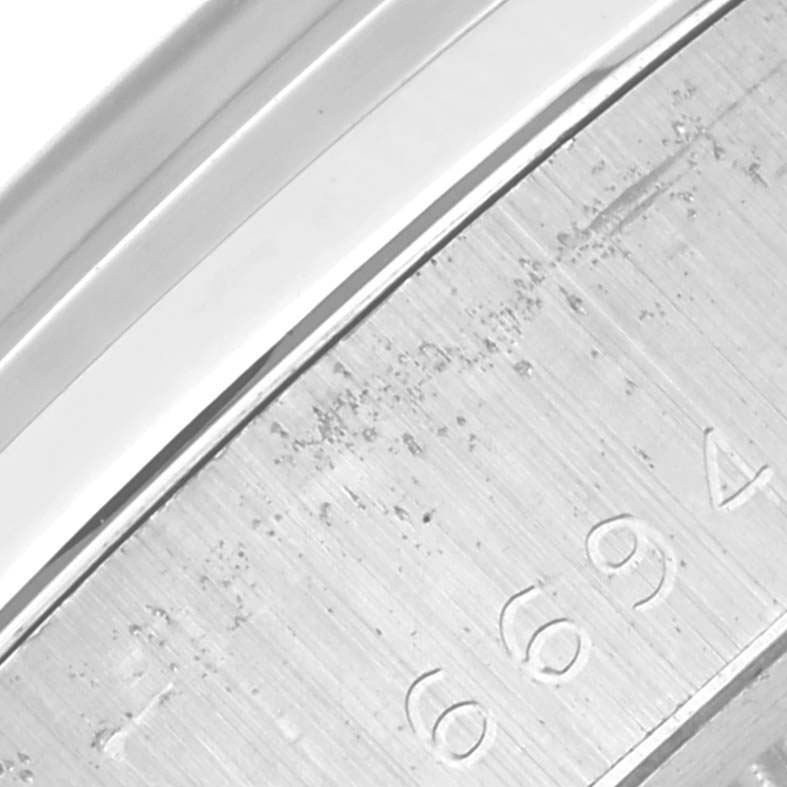 The image shows a close-up of the engraved serial number on the casing side of a Rolex Vintage Collection 6694 Men's Stainless Steel Blue Dial 6694 Men's Stainless Steel Blue Dial watch.
