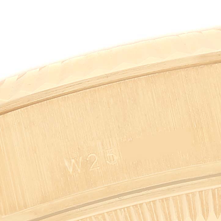This image shows a close-up of the side bezel and part of the case with engraving on a Rolex President 69178 Women's Yellow Gold Champagne Dial 69178 Women's Yellow Gold Champagne Dial model watch.