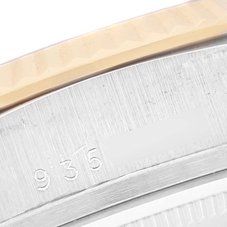 This close-up image shows part of the bezel and casing of a Rolex President 18039B Men's White Gold Brown Dial 18039B Men's White Gold Brown Dial model, showcasing the serial number engraving.