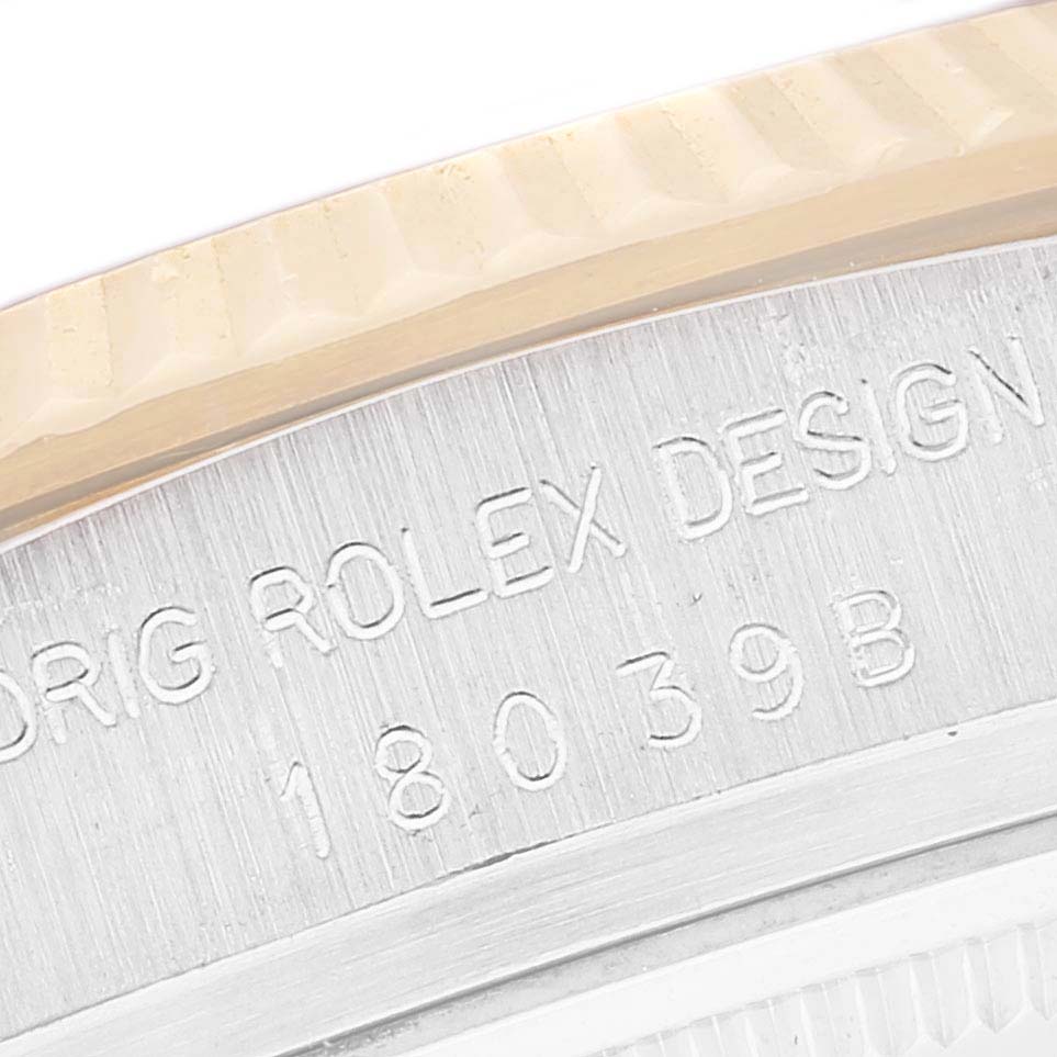This image shows a close-up of the Rolex President 18039B Men's White Gold Brown Dial 18039B Men's White Gold Brown Dial model's engraved bezel and serial number details.