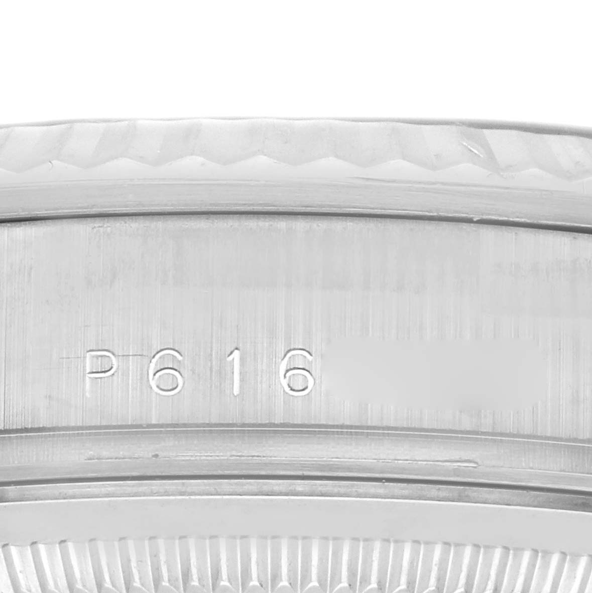 This image shows a close-up of the serial number inscribed on the inner bezel of a Rolex President 118239 Men's White Gold Silver Dial 118239 Men's White Gold Silver Dial model watch.