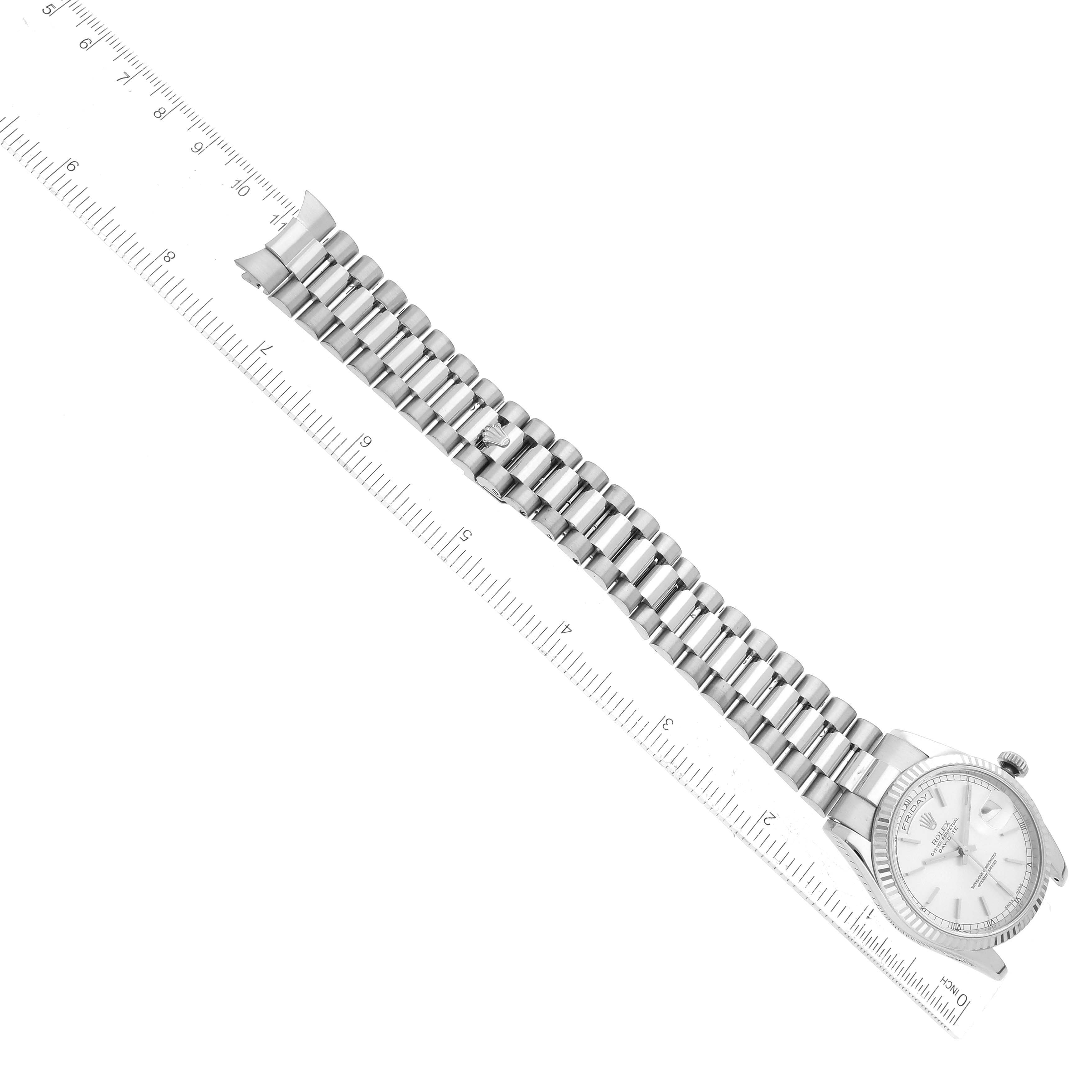 The image shows the Rolex President 118239 Men's White Gold Silver Dial 118239 Men's White Gold Silver Dial model watch placed diagonally next to a ruler, highlighting the watch band and face.