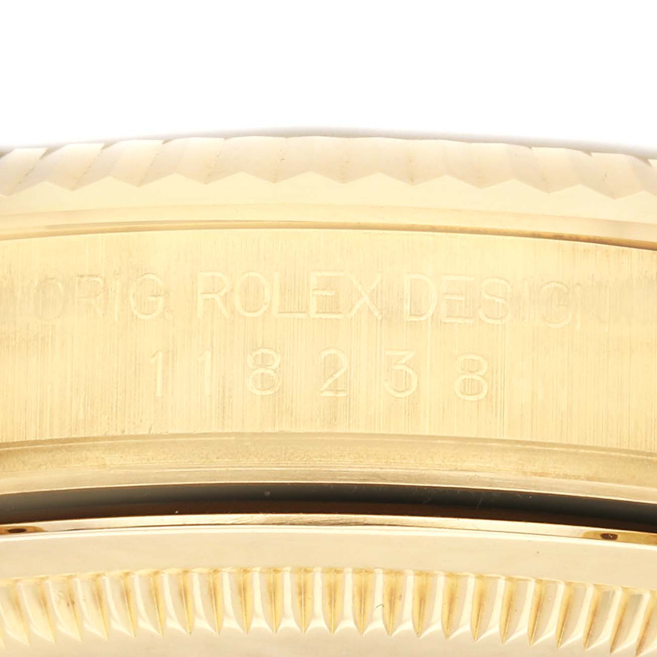 This close-up image of the Rolex President 118238 Men
s Yellow Gold Champagne Dial 118238 Men
s Yellow Gold Champagne Dial model displays the engraved serial numbers on the watch
s case.