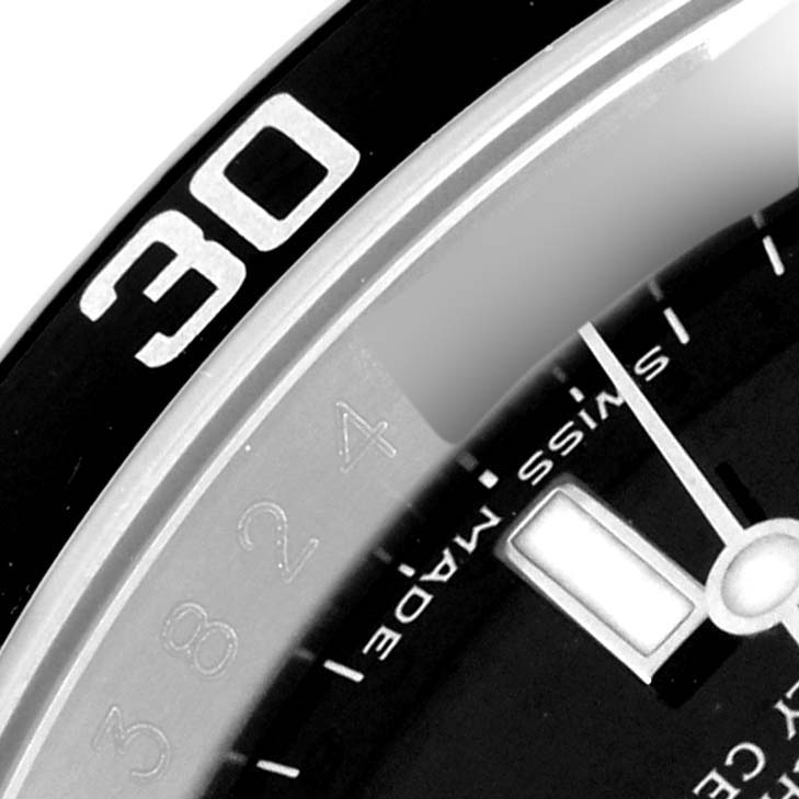 This close-up shows the bezel and part of the dial of a Rolex Submariner 16610 Men's Stainless Steel Black Dial 16610 Men's Stainless Steel Black Dial watch at an angle.