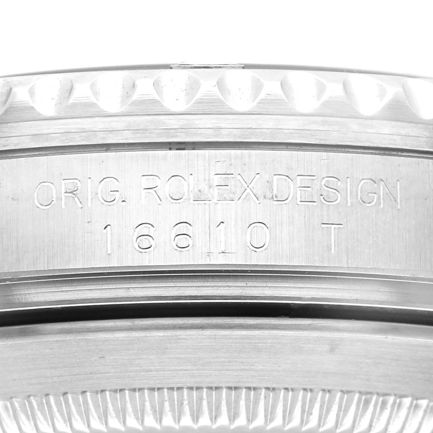 The image shows a close-up angle of the case side of a Rolex Submariner 16610 Men
s Stainless Steel Black Dial 16610 Men
s Stainless Steel Black Dial model, displaying the engraved "ORIG. ROLEX DESIGN 16610 T".