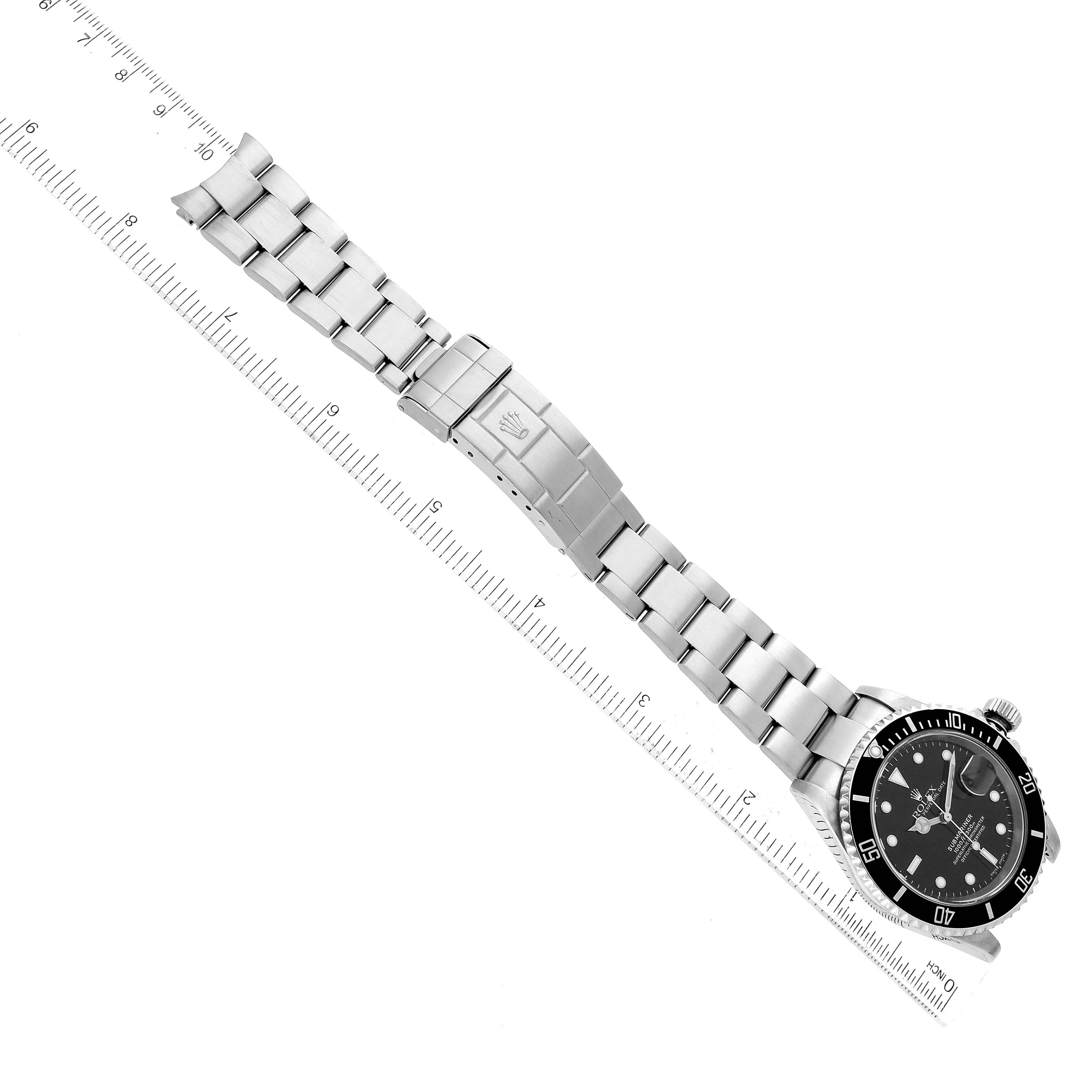 The image shows an overhead view of a Rolex Submariner 16610 Men
s Stainless Steel Black Dial 16610 Men
s Stainless Steel Black Dial watch, displaying its entire stainless steel bracelet and clasp.