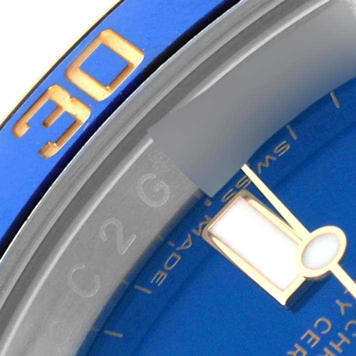 The image shows a close-up of the bezel and dial of a Rolex Submariner 64733 Men's Steel and Gold (two tone) Blue Dial 64733 Men's Steel and Gold (two tone) Blue Dial watch, focusing on the 30-minute marker and the second hand.