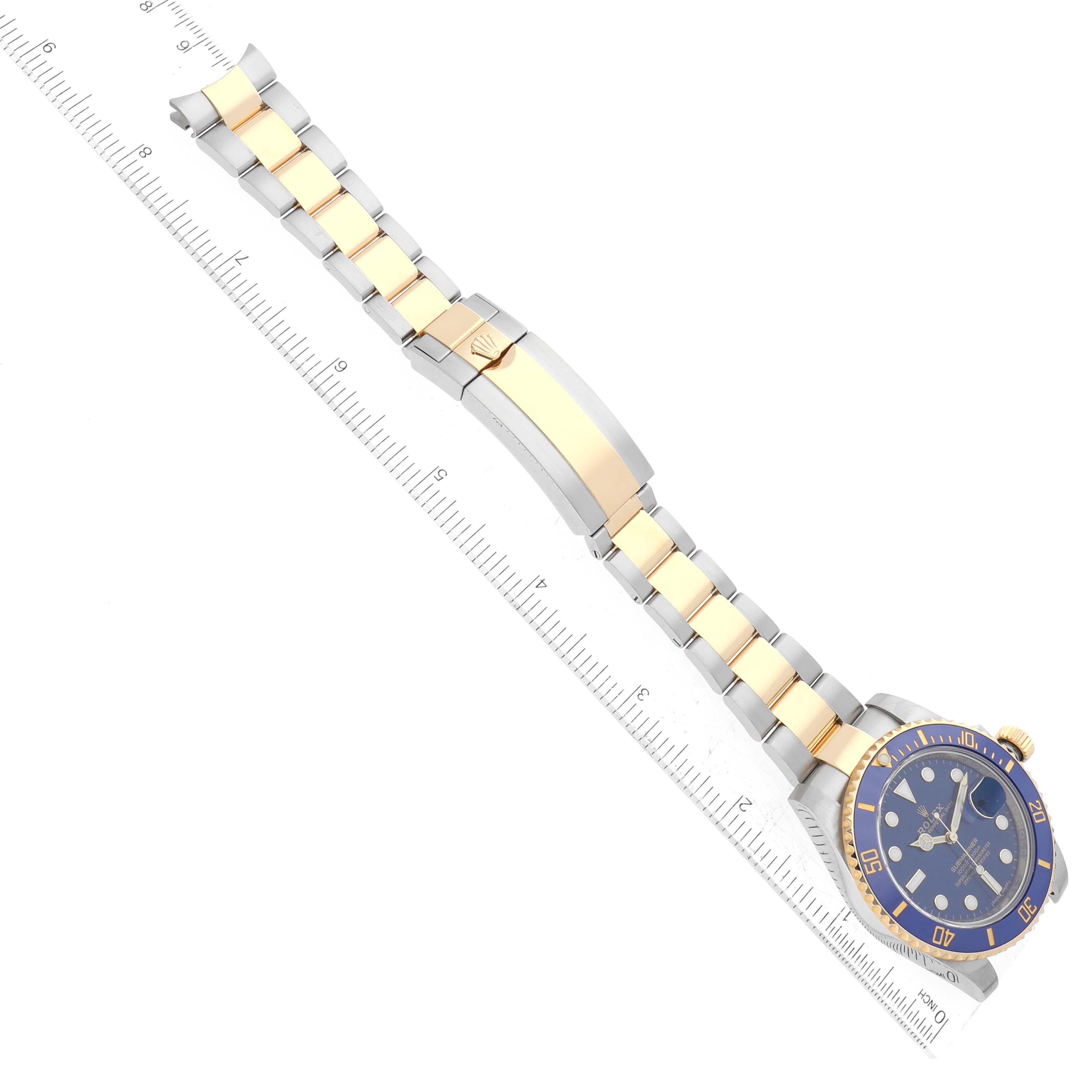 This image shows a Rolex Submariner 64733 Men's Steel and Gold (two tone) Blue Dial 64733 Men's Steel and Gold (two tone) Blue Dial watch at an overhead angle, highlighting its bracelet, clasp, and face.