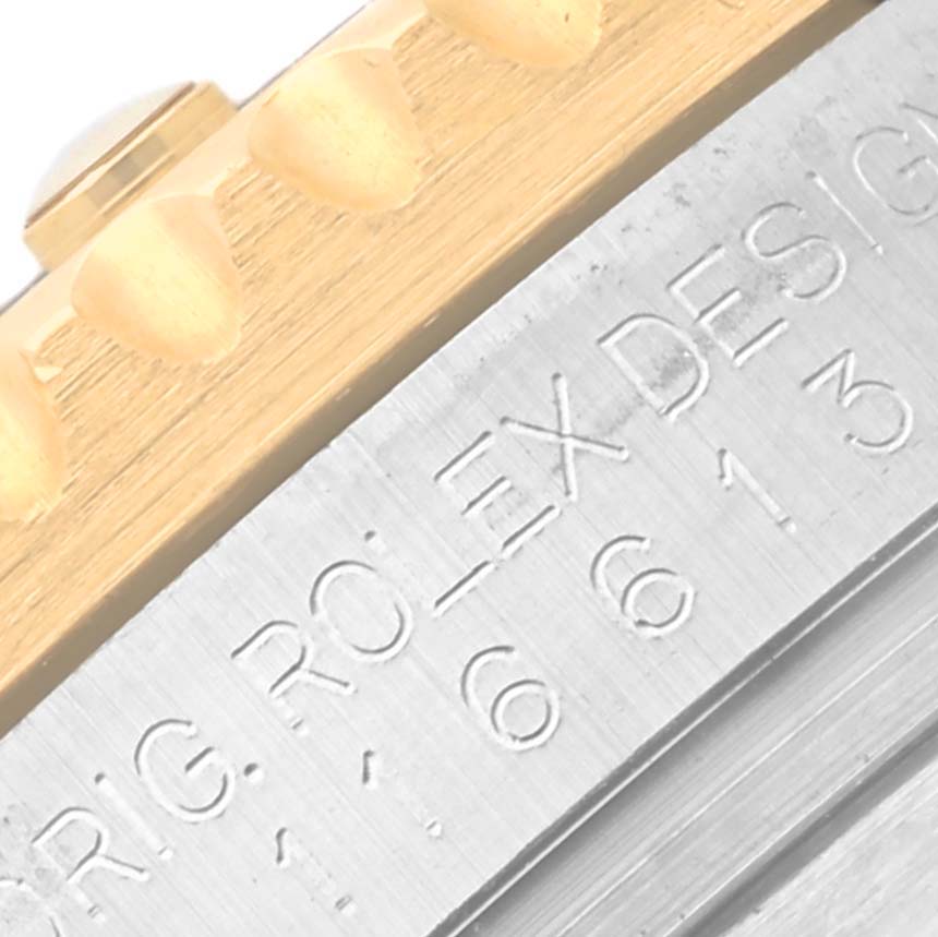 This image shows a close-up of the side of a Rolex Submariner 64733 Men's Steel and Gold (two tone) Blue Dial 64733 Men's Steel and Gold (two tone) Blue Dial, focusing on the engraved edge between the bezel and case.