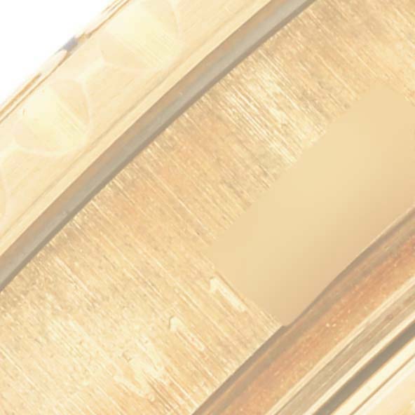 The image shows a close-up of a section of the bezel on a Rolex Yacht-Master 69628 Women's Yellow Gold Blue Dial 69628 Women's Yellow Gold Blue Dial watch.