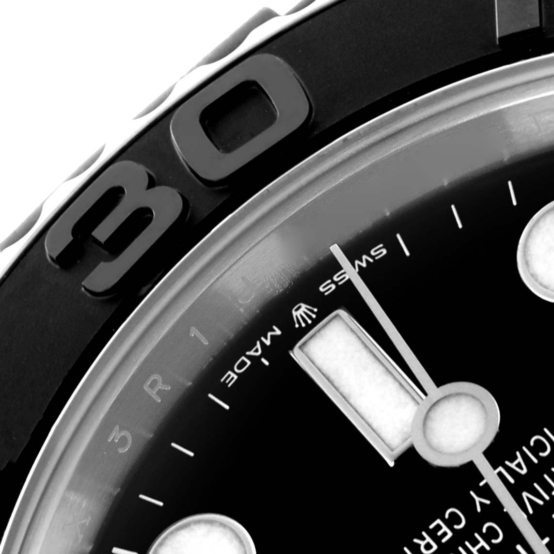 The image shows a close-up of the Rolex Yacht-Master 226659 Men's White Gold Black Dial, highlighting part of the bezel, dial, and a minute hand.