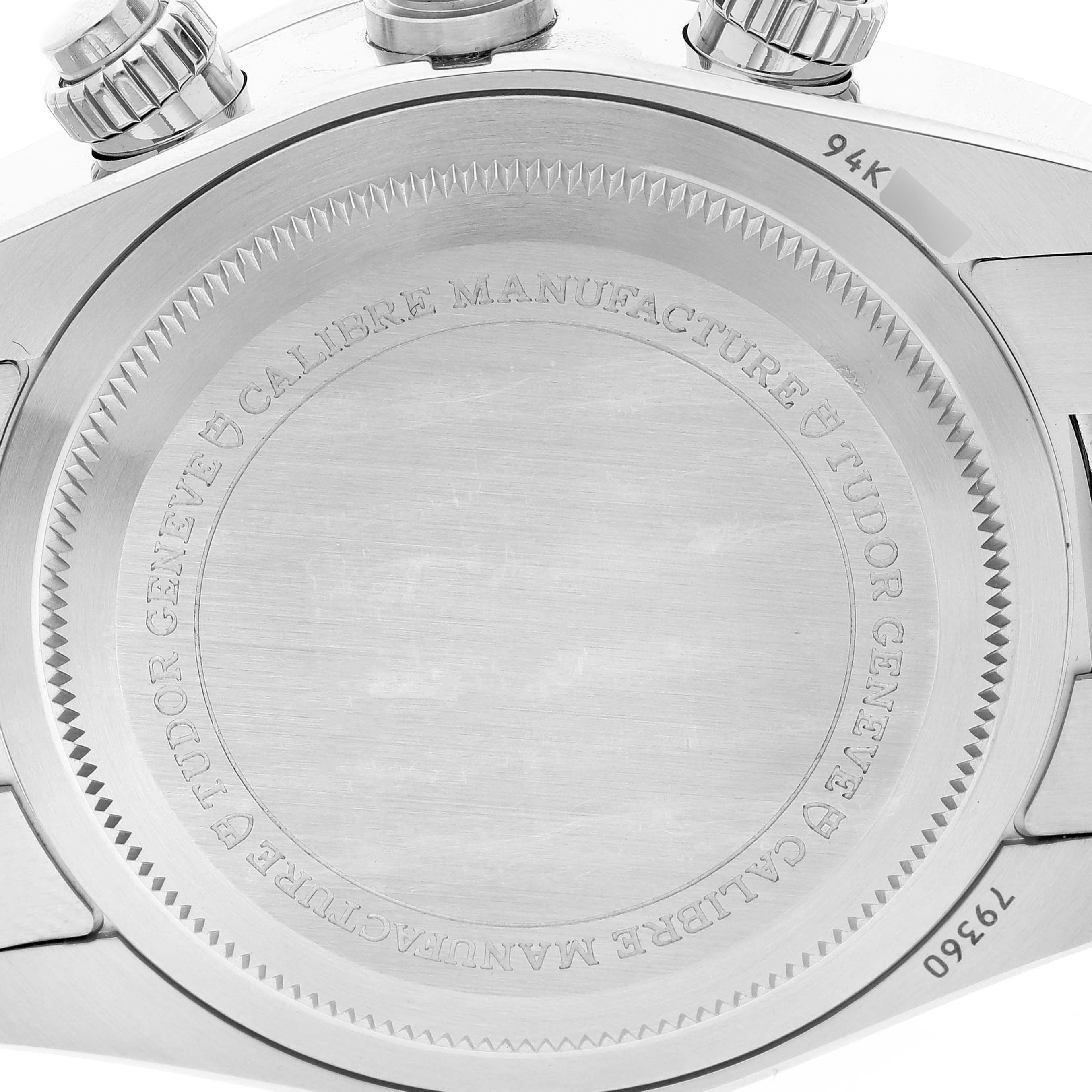The image shows the back case of a Tudor Heritage Black Bay watch, highlighting the engraved details and crown.