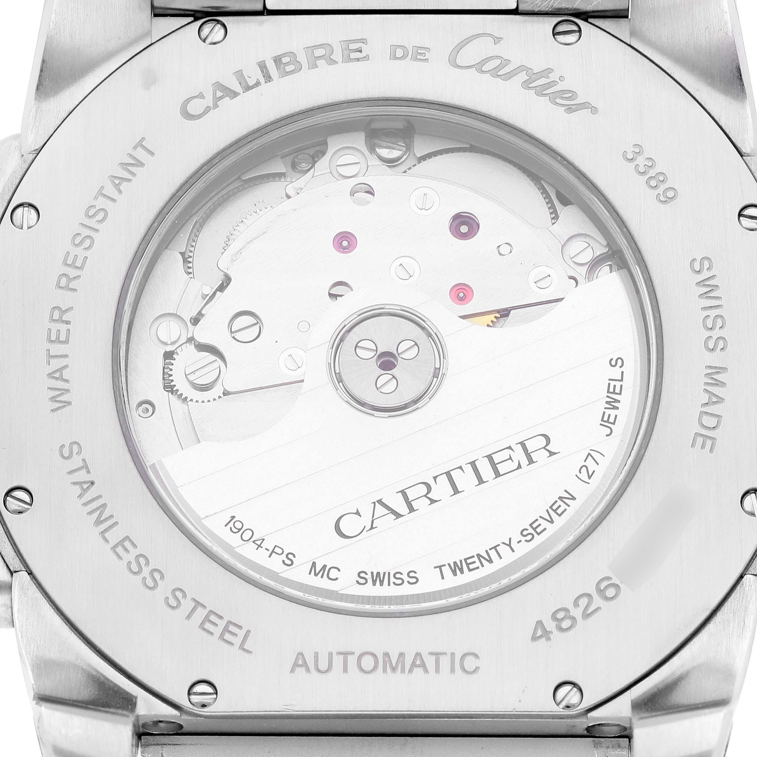 The image shows the case back of a Calibre de Cartier watch by Cartier, revealing the automatic movement inside.