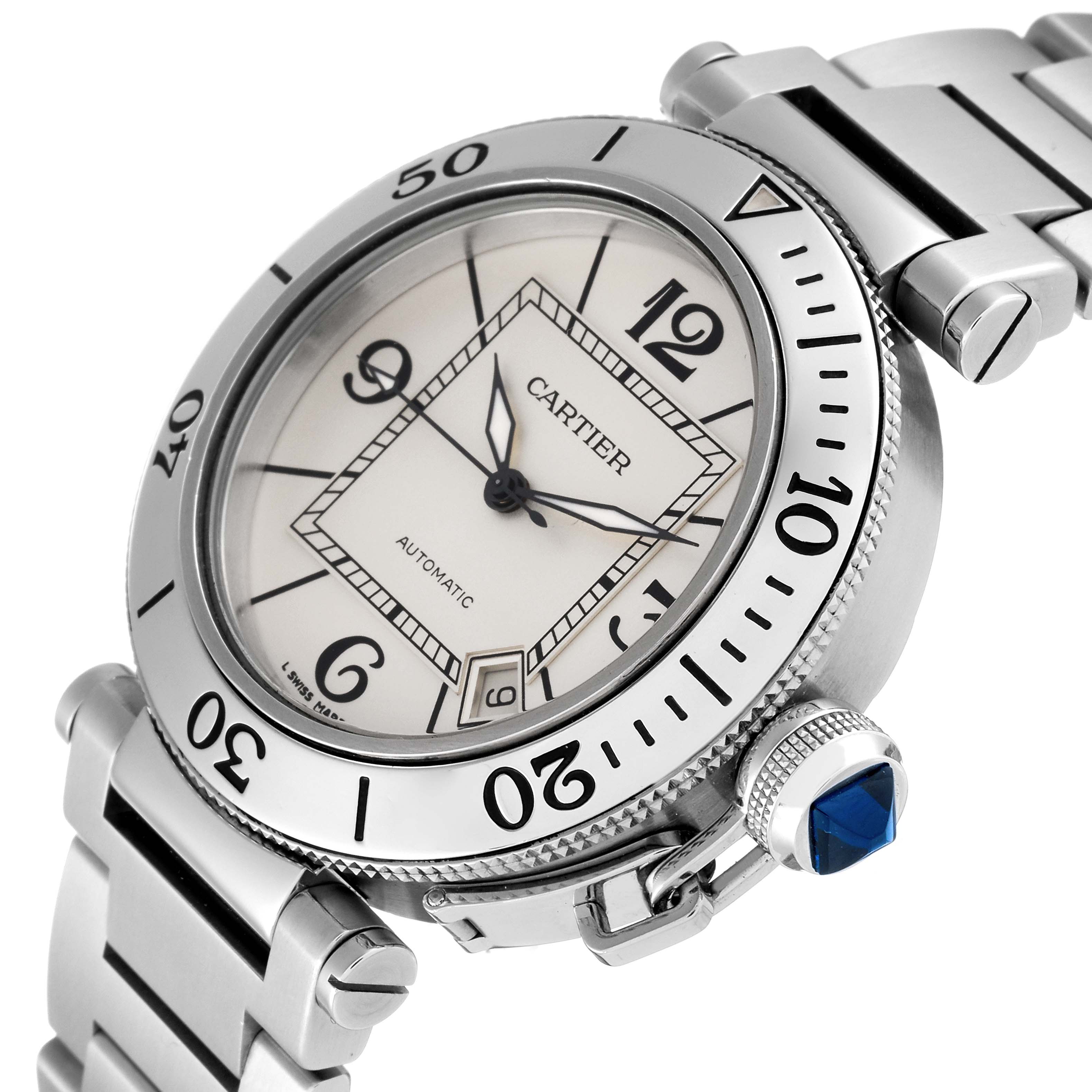 The Cartier Pasha W31080M7 Men's Stainless Steel Silver Dial W31080M7 Men's Stainless Steel Silver Dial watch is shown at an angle highlighting the face, bezel, bracelet, and distinctive crown with a blue gemstone.