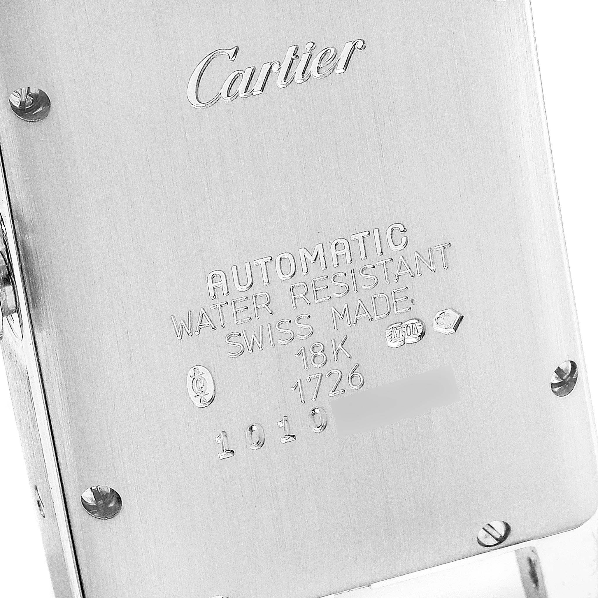 The image shows the case back of a Cartier Tank Americaine 1726 Women's White Gold Silver Dial 1726 Women's White Gold Silver Dial watch, displaying engravings and screws.