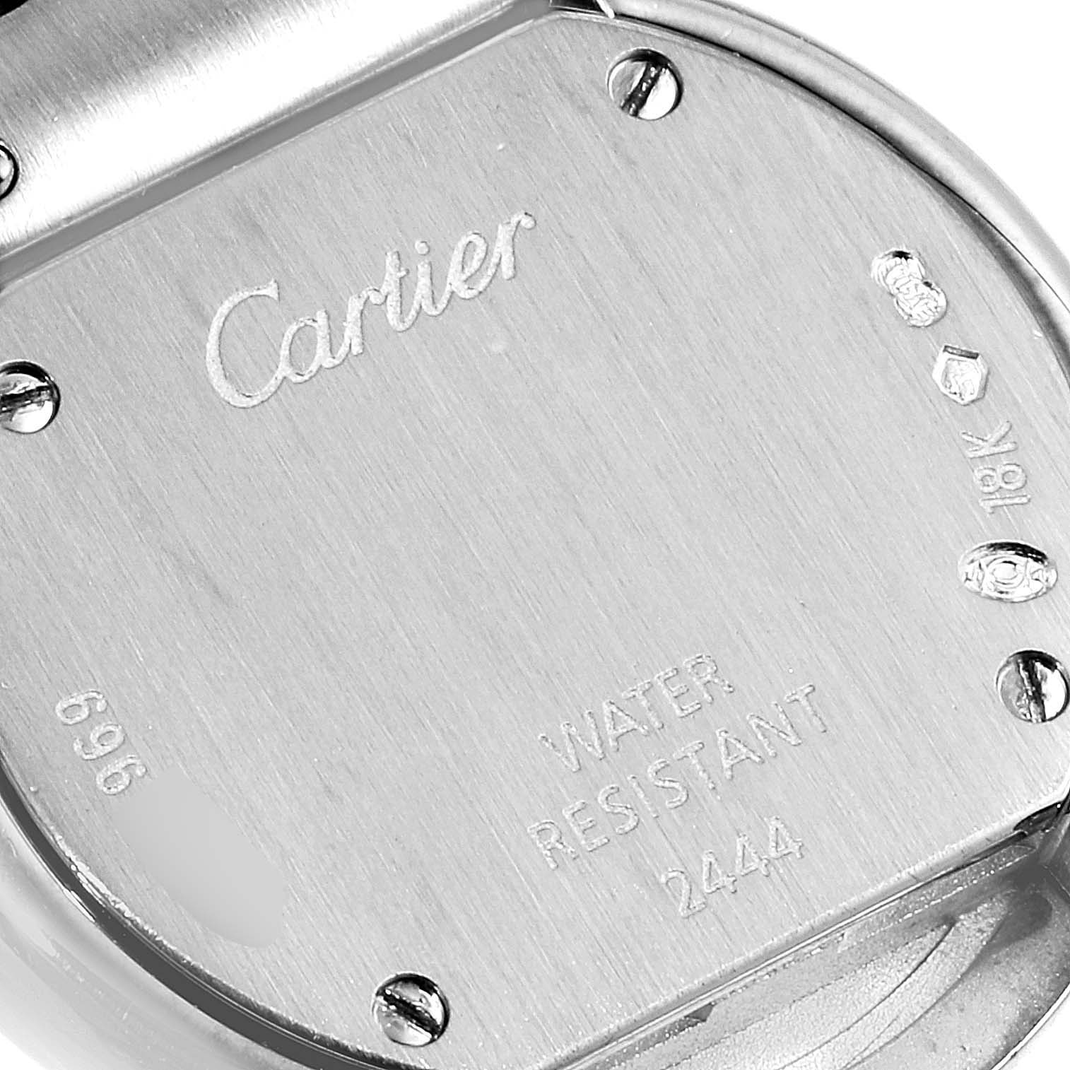 This image shows a close-up of the back case of a Cartier Trinity 2444 Women's White Gold Silver Dial 2444 Women's White Gold Silver Dial model watch, highlighting the engraved details and screws.