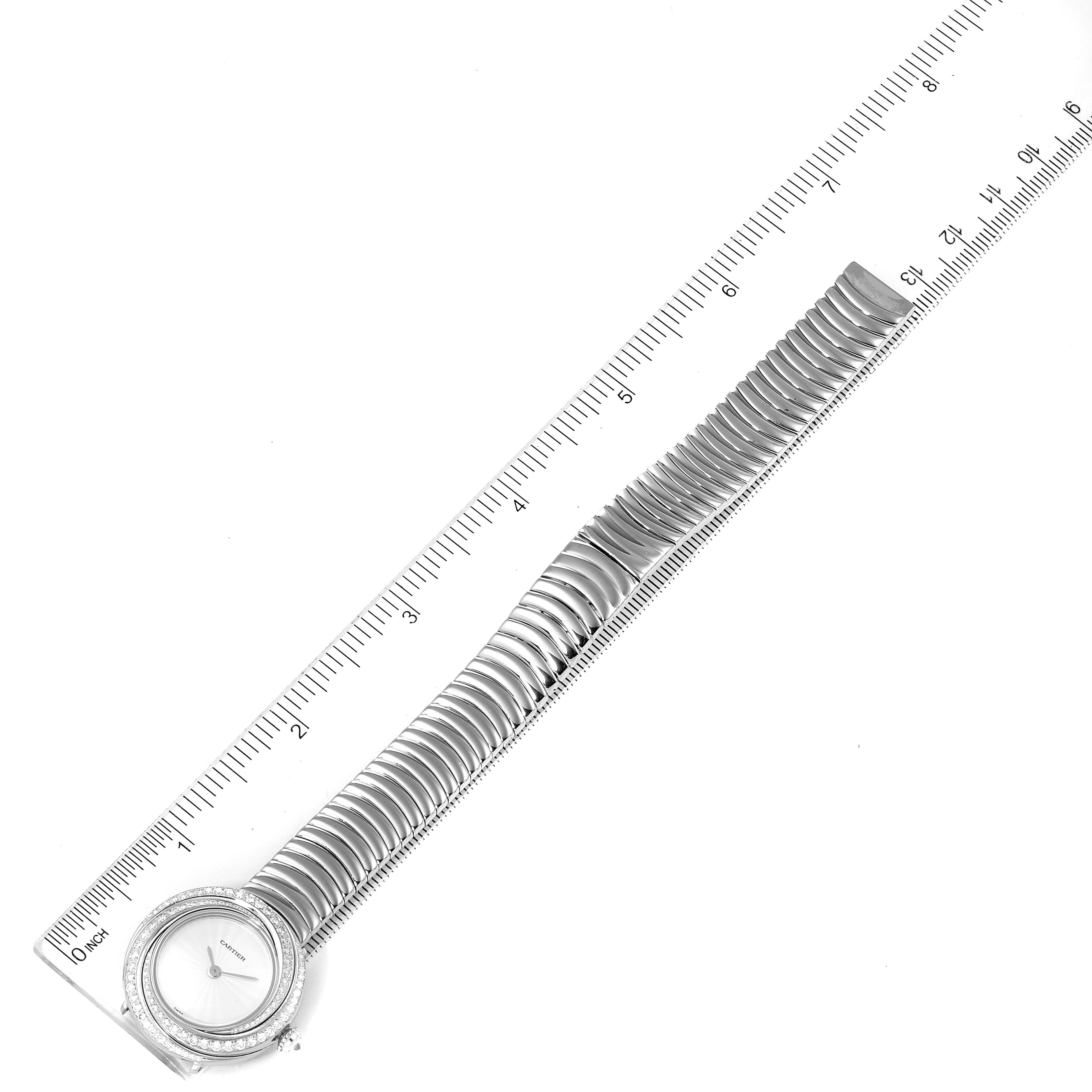 The Trinity model by Cartier is shown from a top-down angle, displaying the full watch, including the face and the entire metal strap beside a ruler.