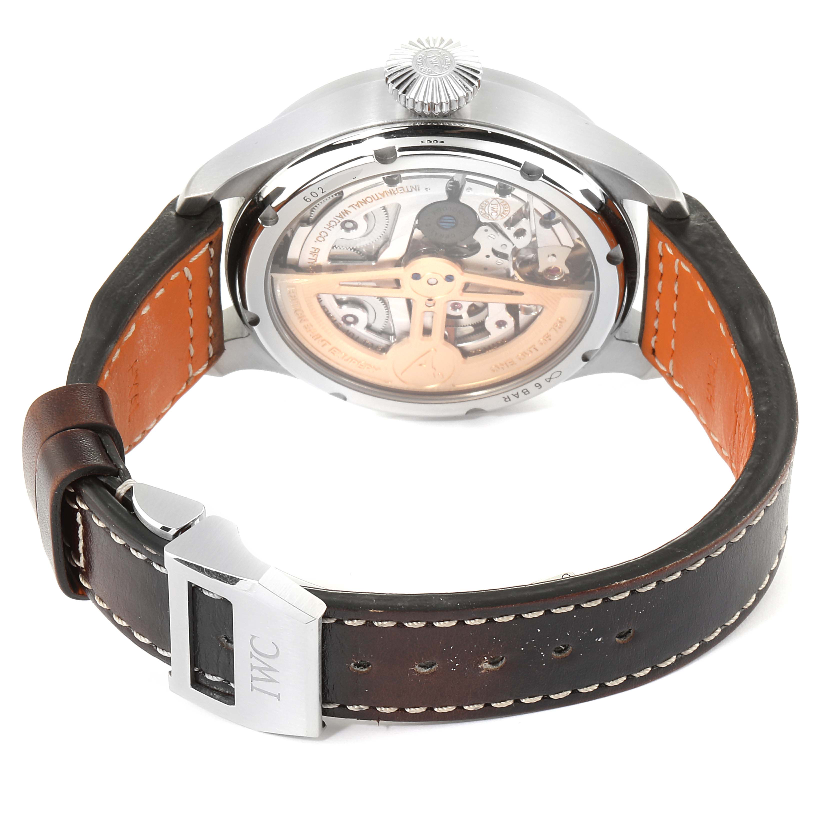 The IWC Pilot IW503801 Men
s Stainless Steel Brown Dial IW503801 Men
s Stainless Steel Brown Dial model watch is shown from the back, displaying its intricate movement and leather strap with buckle.