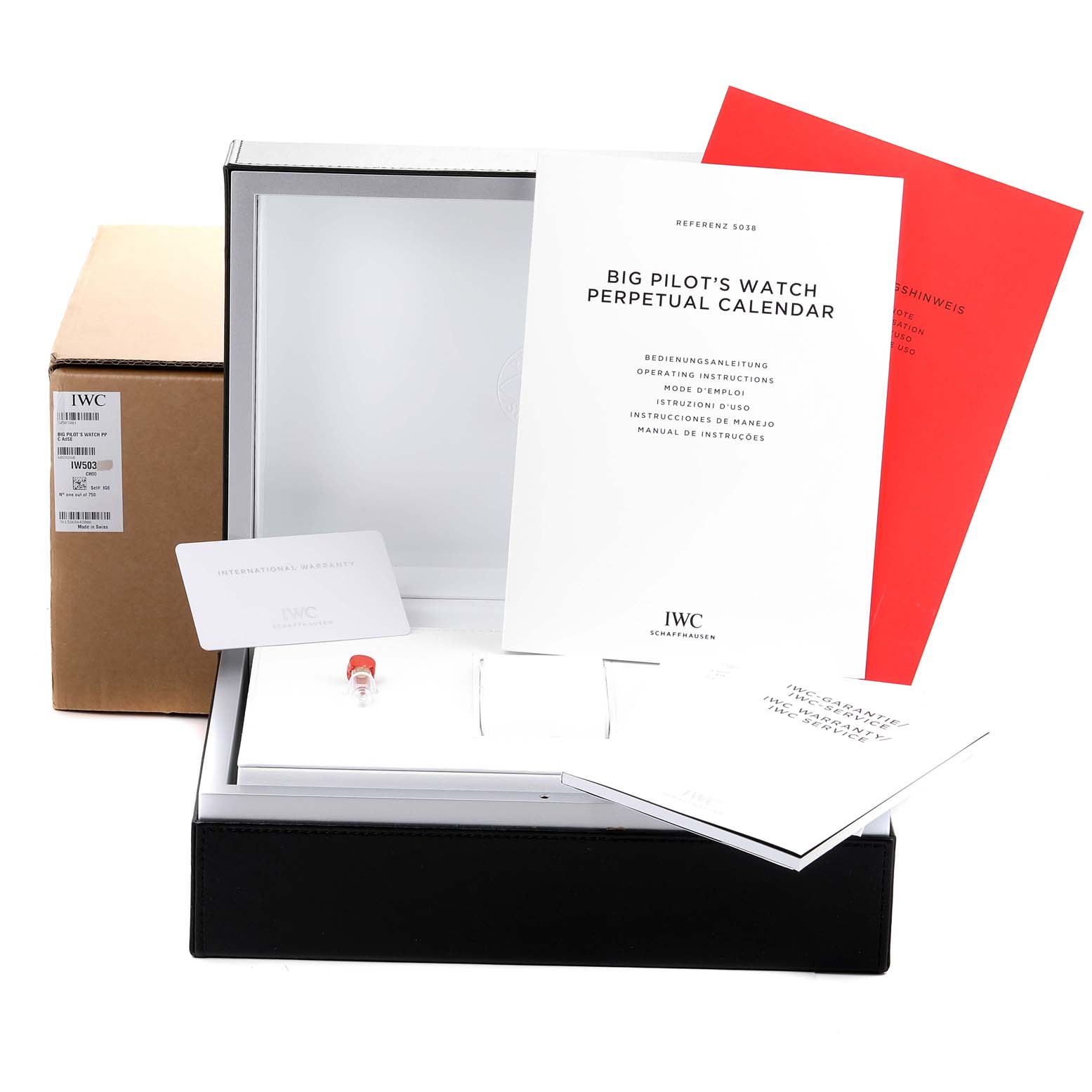 The image shows the packaging, manuals, and accessories for the IWC Big Pilot
s Watch Perpetual Calendar, arranged inside an open box.