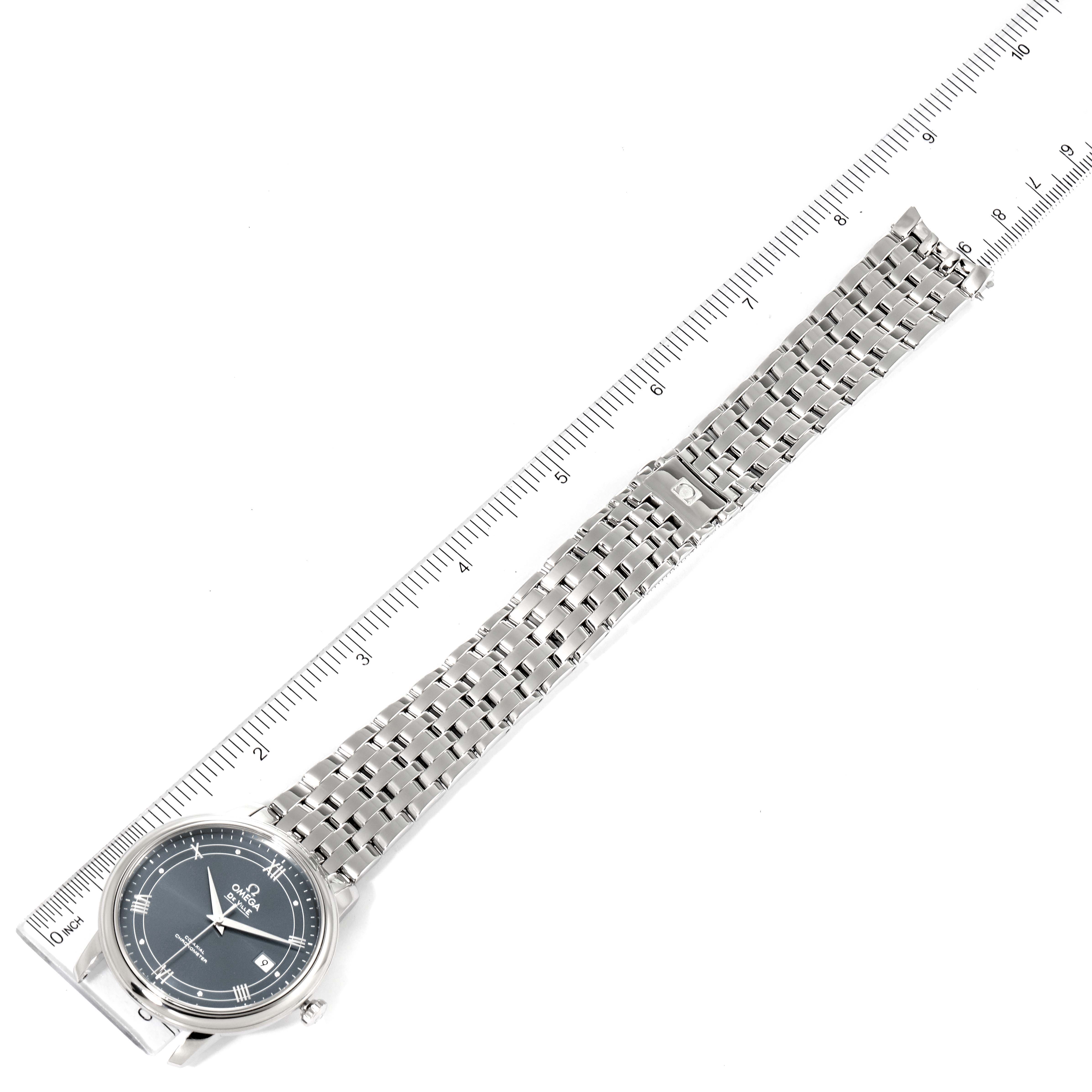 The image shows an Omega De Ville 424.10.40.20.03.002 Men's Stainless Steel Blue Dial 424.10.40.20.03.002 Men's Stainless Steel Blue Dial watch laid flat, displaying the entire watch face and metal bracelet with a ruler for scale.