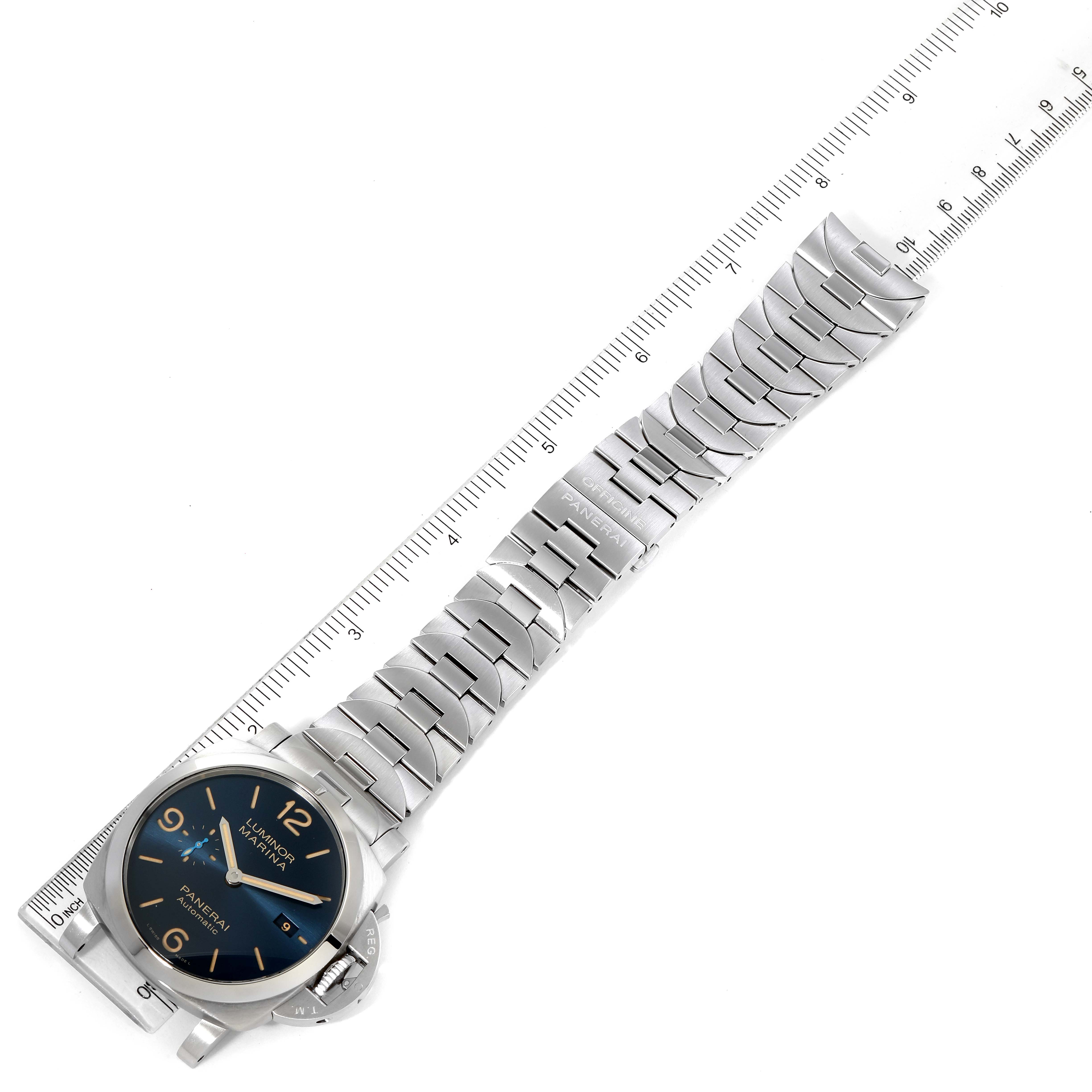 The image shows a Panerai Luminor PAM00958 Men's Stainless Steel Blue Dial PAM00958 Men's Stainless Steel Blue Dial watch with a metal band at an angled top-down view, alongside a ruler for scale.