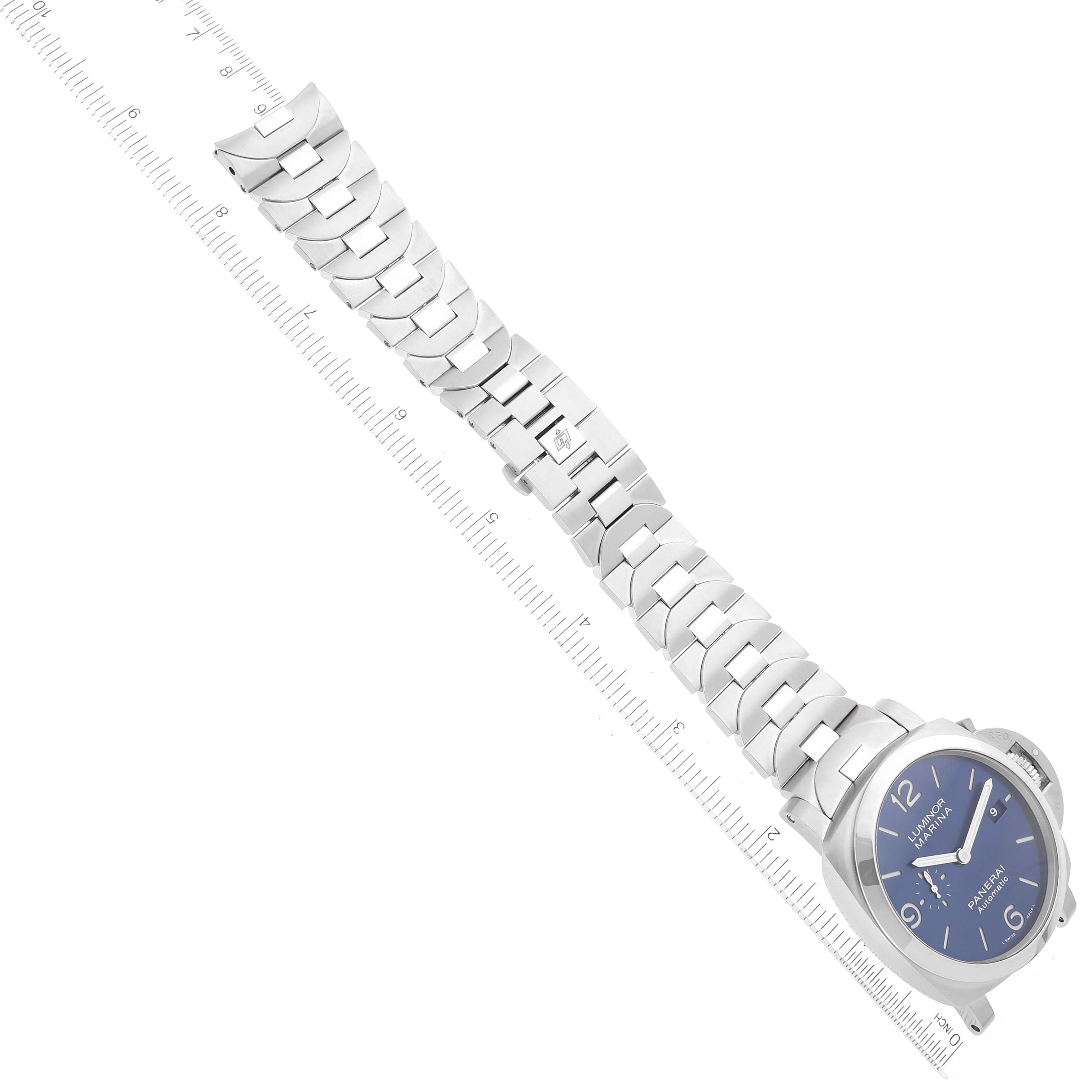 The image shows a Panerai Luminor PAM01316 Men's Stainless Steel Blue Dial PAM01316 Men's Stainless Steel Blue Dial watch laid flat with a metal link bracelet alongside a transparent ruler for scale.