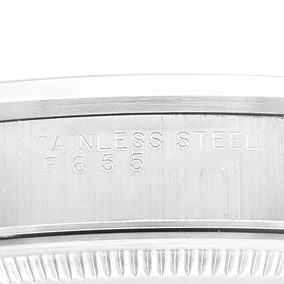 This image shows a close-up of the stainless steel casing and serial number of a Rolex Air-King 14000 Men's Stainless Steel Blue Dial 14000 Men's Stainless Steel Blue Dial watch.