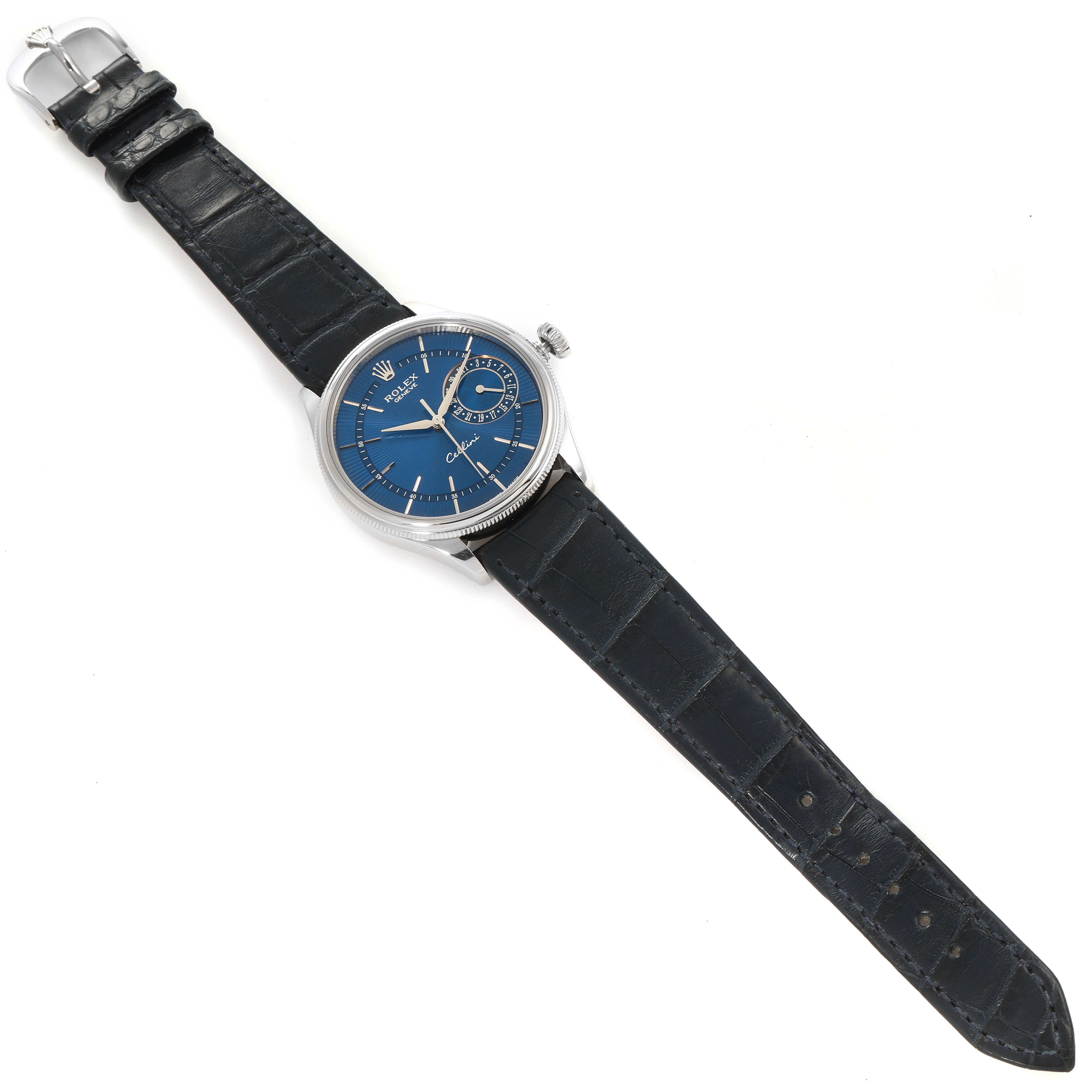 The Rolex Cellini 50519 Men's White Gold Blue Dial 50519 Men's White Gold Blue Dial watch is shown from an overhead angle, displaying its blue dial, silver case, and leather strap.