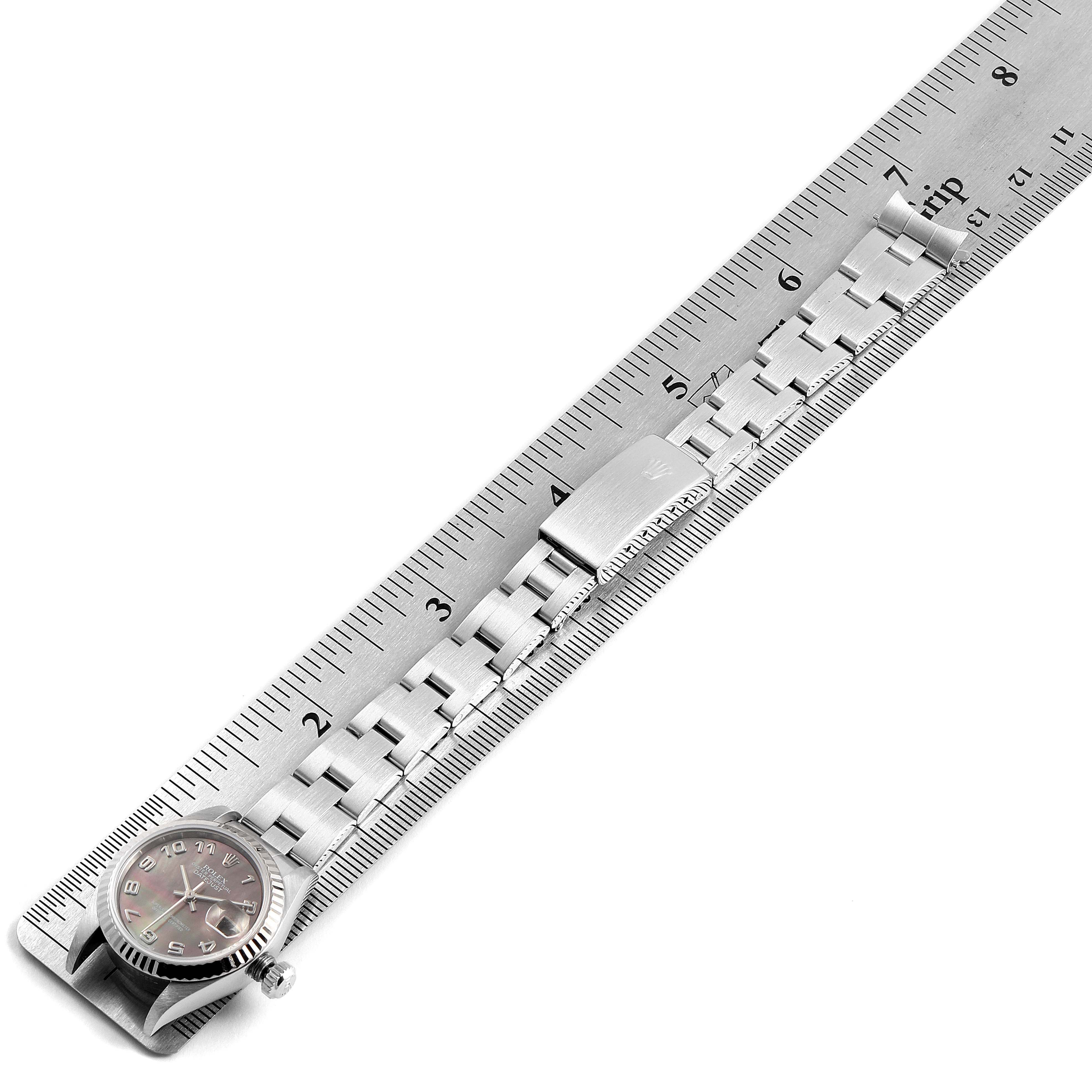 The image shows a Rolex Datejust 79174 Women's Stainless Steel Mother of Pearl Dial 79174 Women's Stainless Steel Mother of Pearl Dial watch lying flat, measured against a metal ruler.