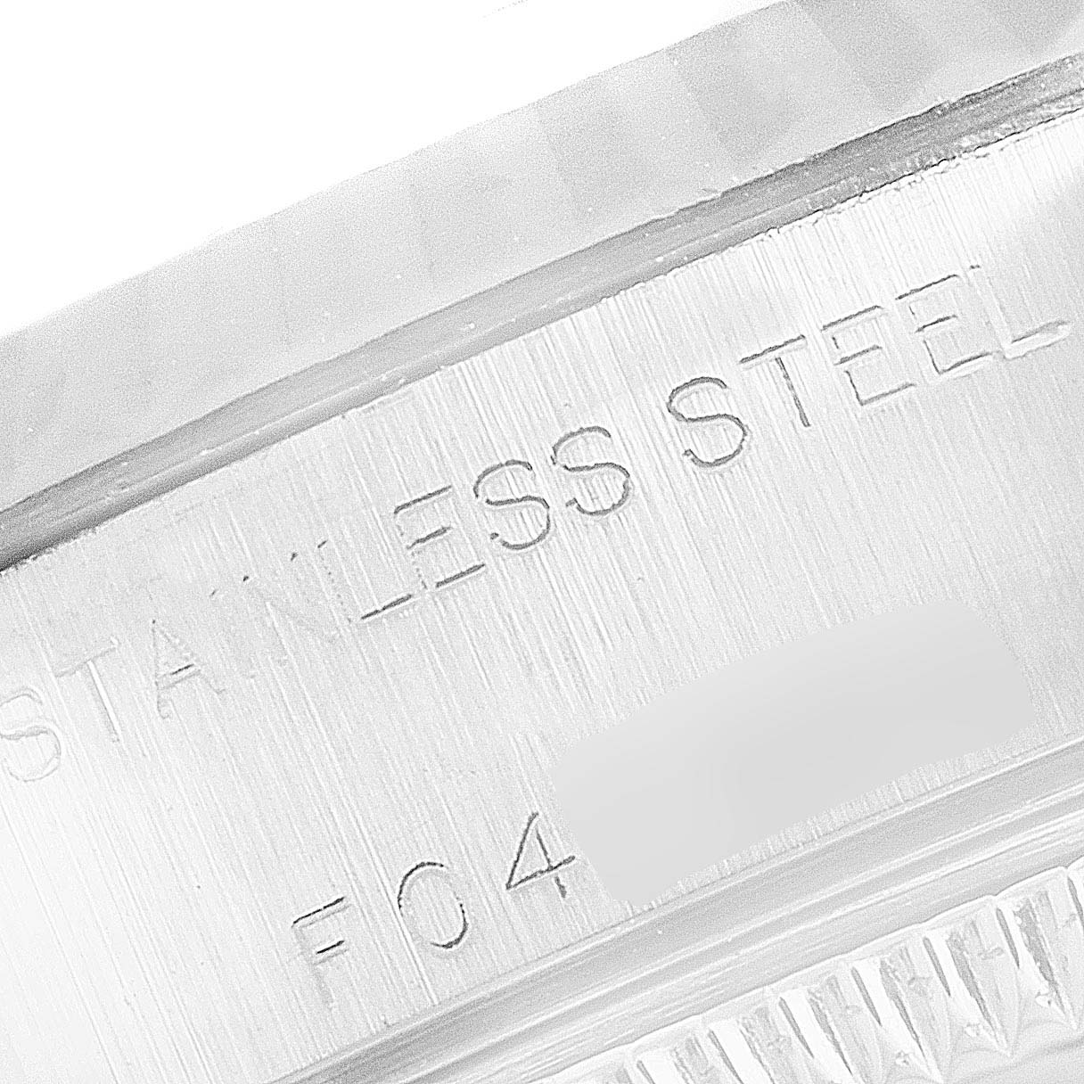 This image shows a close-up of the casing of a Rolex Datejust 79174 Women's Stainless Steel Mother of Pearl Dial 79174 Women's Stainless Steel Mother of Pearl Dial watch with the "STAINLESS STEEL" engraving visible.