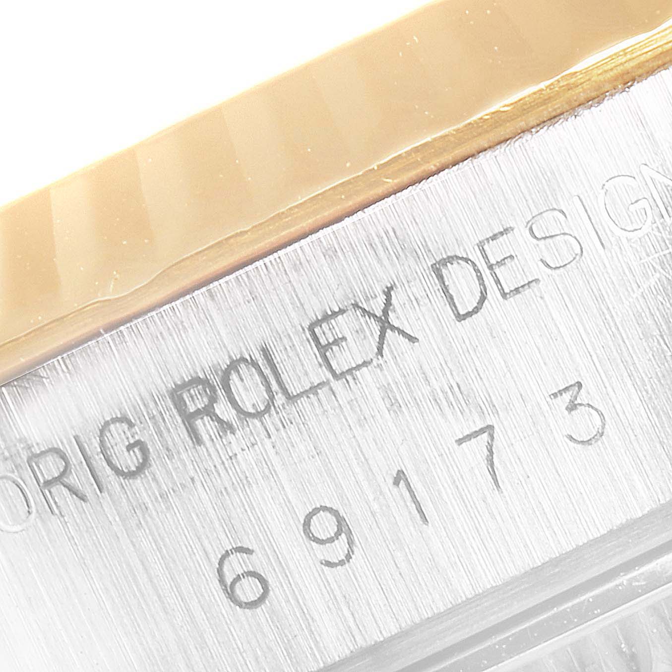 Close-up of the side of a Rolex Datejust 69173 Women's Stainless Steel Champagne Dial 69173 Women's Stainless Steel Champagne Dial watch showing "ORIG ROLEX DESIGN" and the model number 69173.