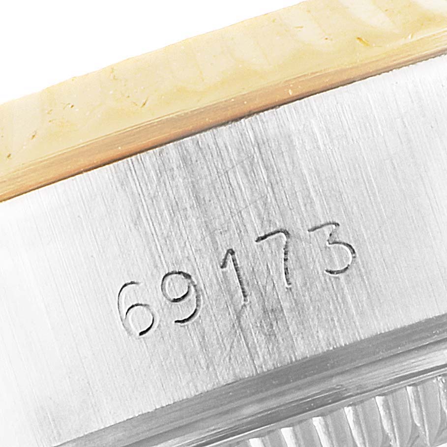 This is a close-up of a Rolex Datejust 69173 Women's Steel and Gold (two tone) Champagne Dial 69173 Women's Steel and Gold (two tone) Champagne Dial watch showing the engraved model number "69173" on the case.