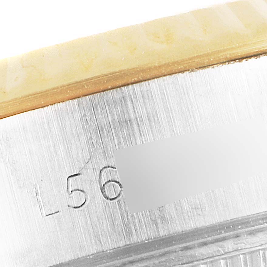 This image shows a macro view of the side of a Rolex Datejust 69173 Women's Steel and Gold (two tone) Champagne Dial 69173 Women's Steel and Gold (two tone) Champagne Dial watch, focusing on the engraved serial number and part of the bezel.