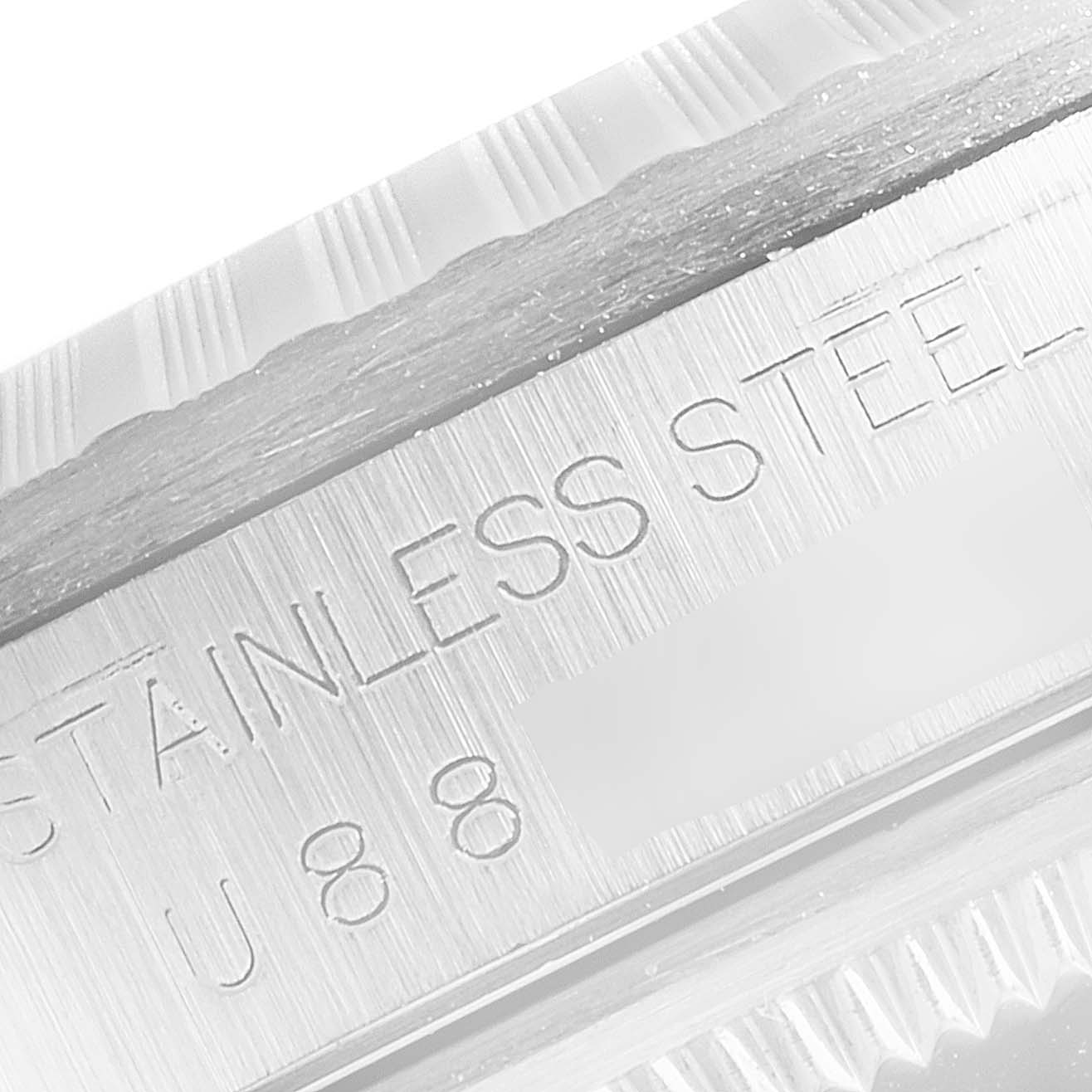 This image shows a close-up of the serial number and "STAINLESS STEEL" engraving on a Rolex Datejust 16220 Men's Stainless Steel Black Dial 16220 Men's Stainless Steel Black Dial model's case.